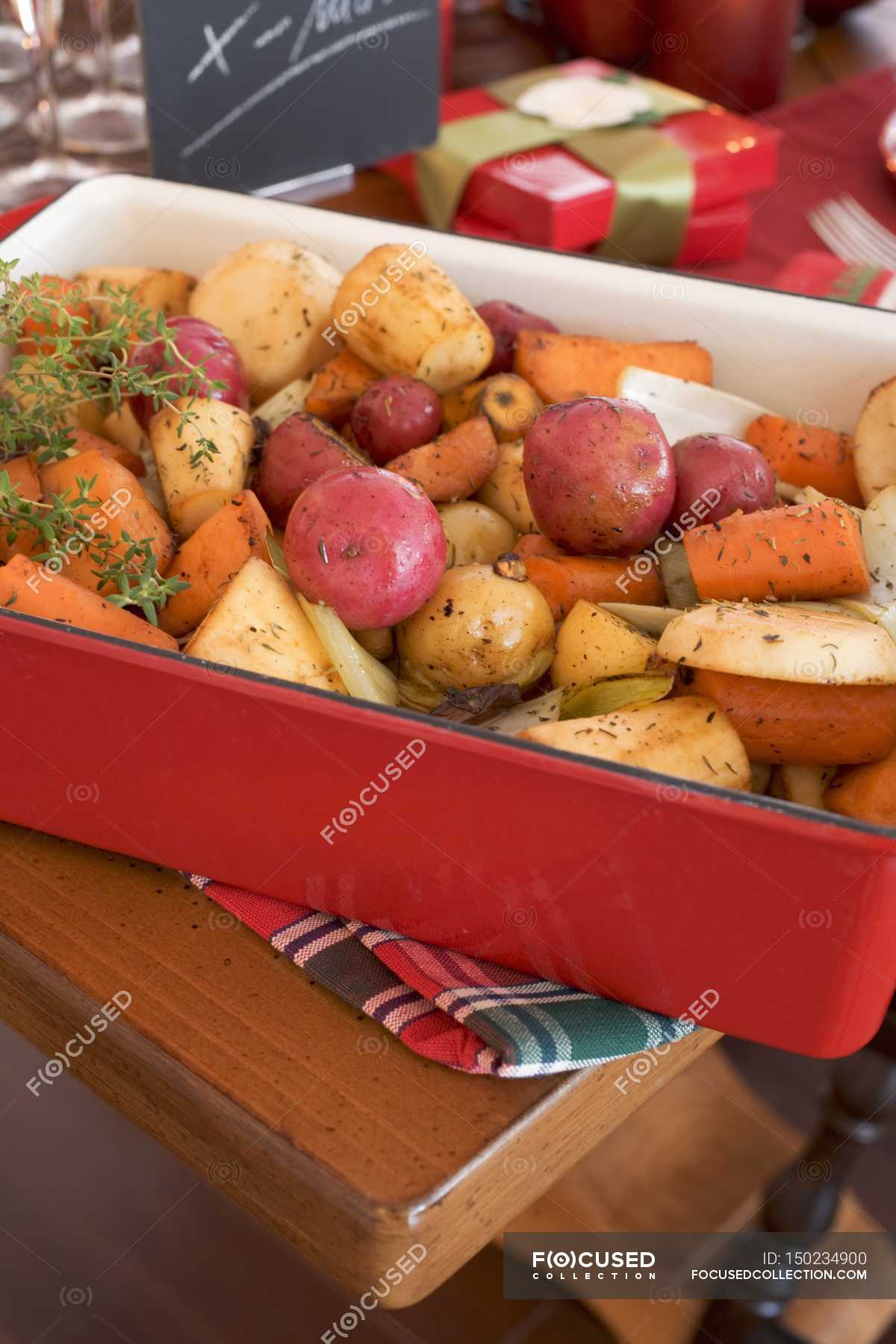 Roasted root vegetables on Christmas table in red dish — agriculture ...