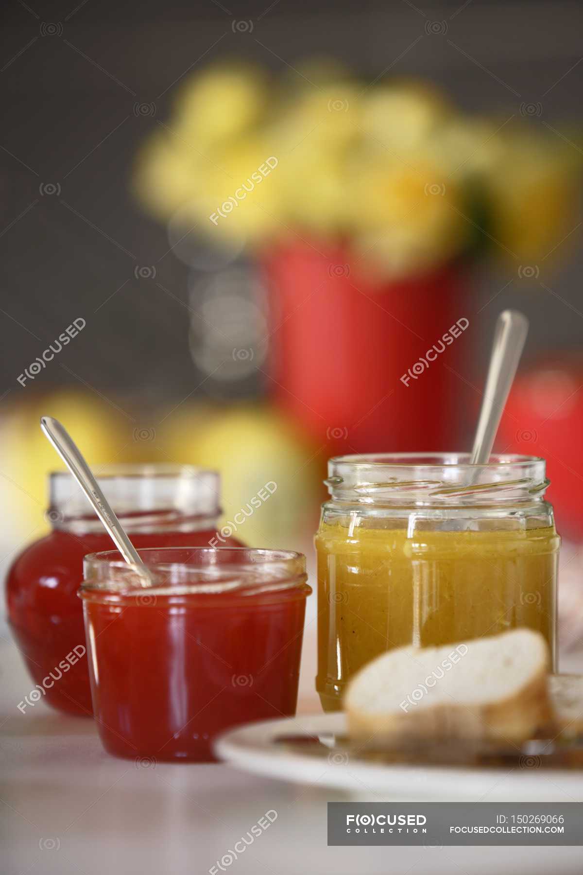 Various jars of jam — spoons, bake Stock Photo 150269066