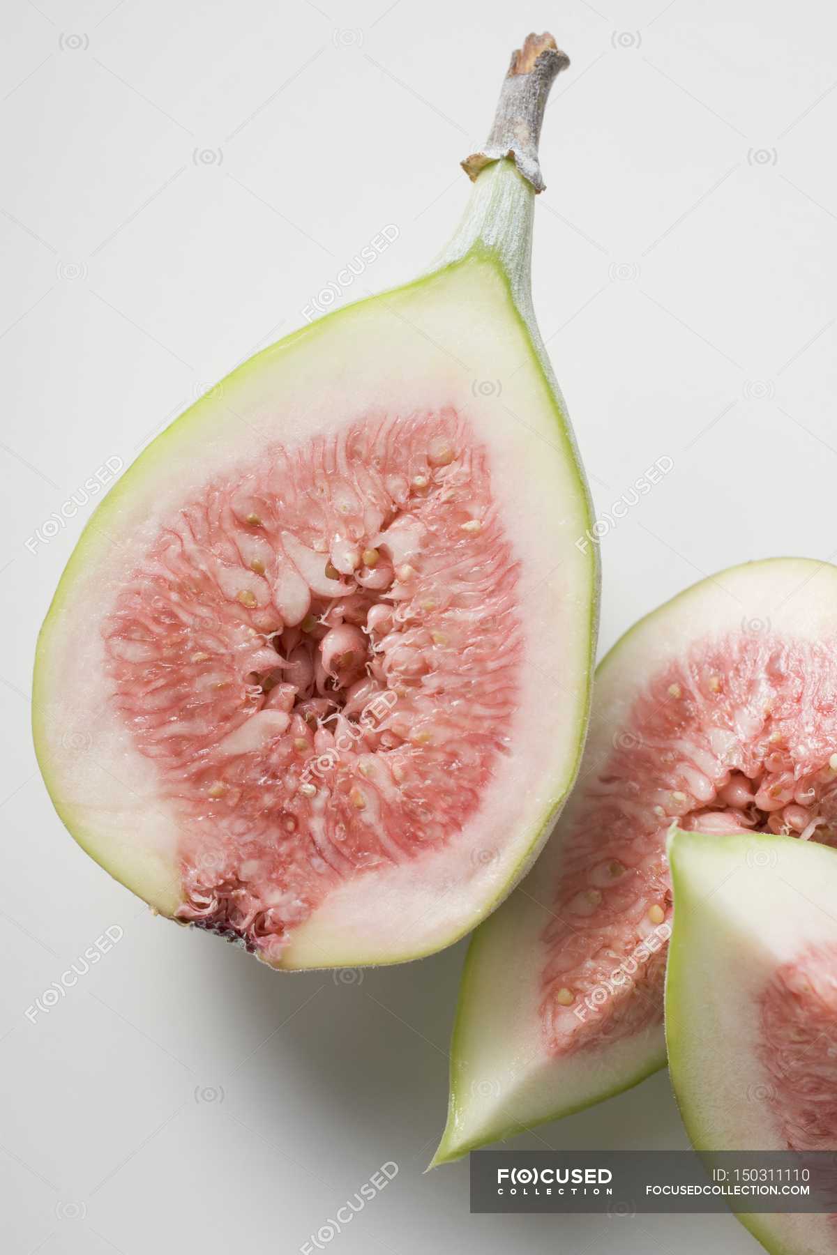 Quarters of fresh figs — organic, Isolated On White Stock Photo