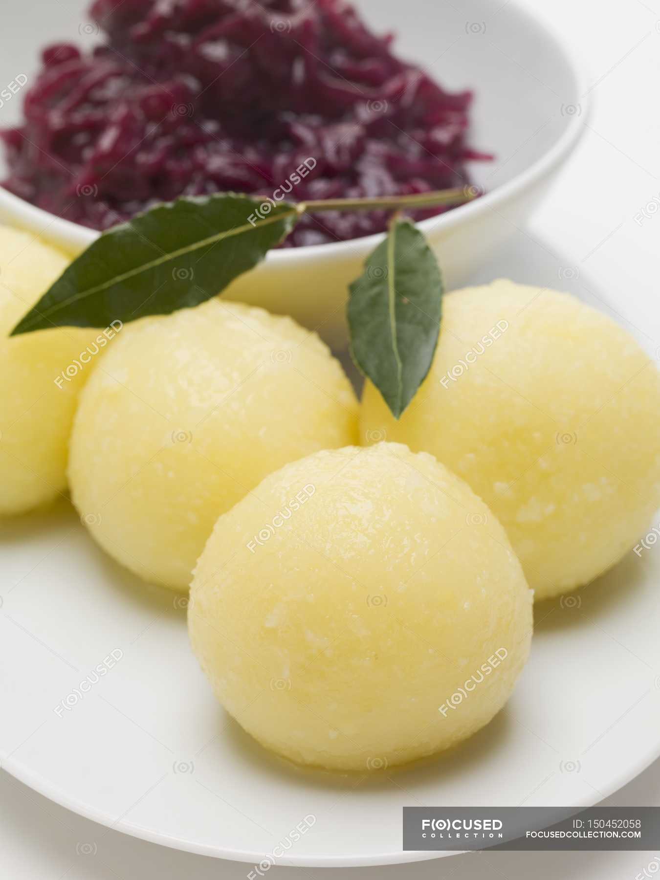 Red cabbage and potato dumplings on white plate — color, gourmet