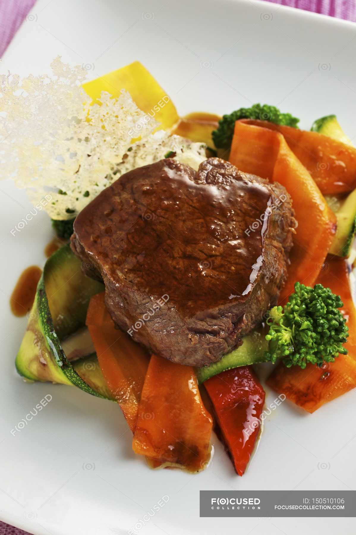 Roasted Fillet of beef on vegetables — close up, recipe Stock Photo