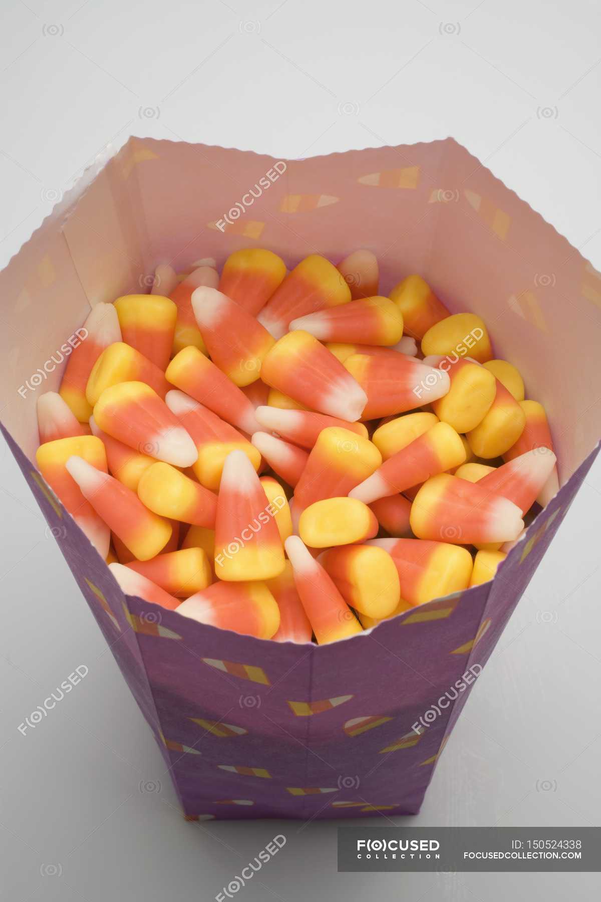 Candy corns in paper bag — seasonal, cooking Stock Photo 150524338