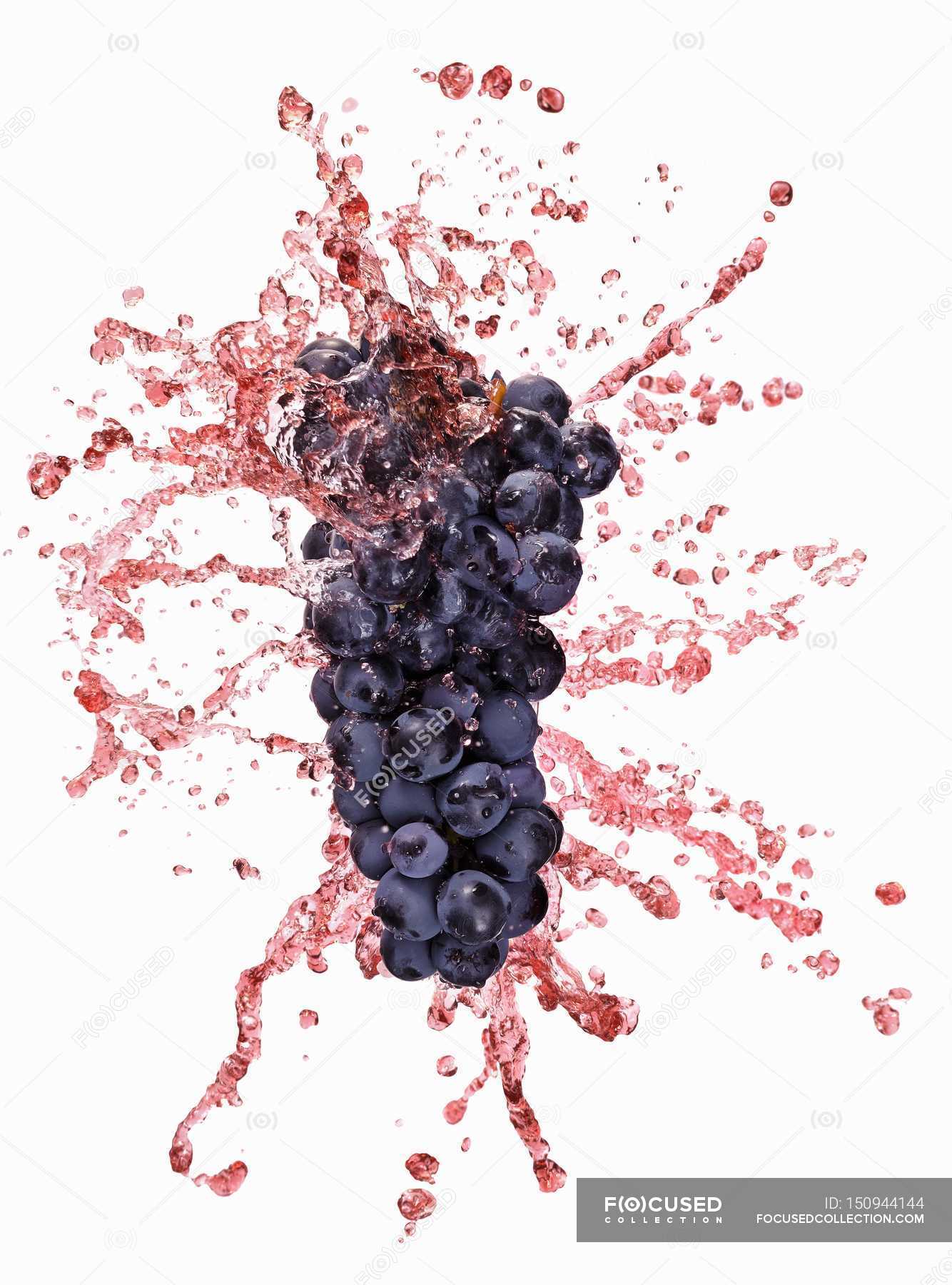 red-grapes-with-juice-splash-eco-organic-stock-photo-150944144