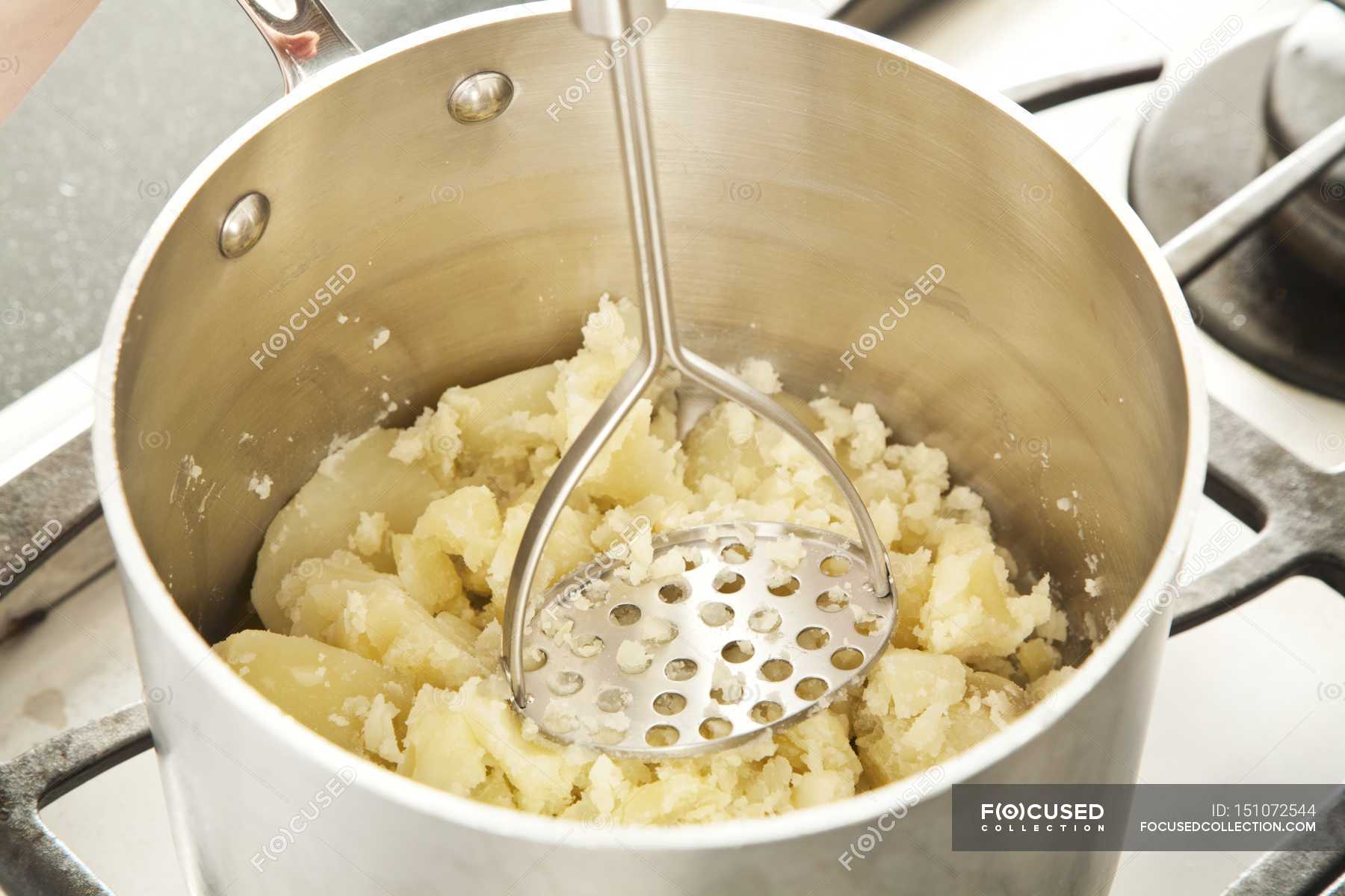 Mashing Potatoes in Pot — tasty, appetizing Stock Photo 151072544
