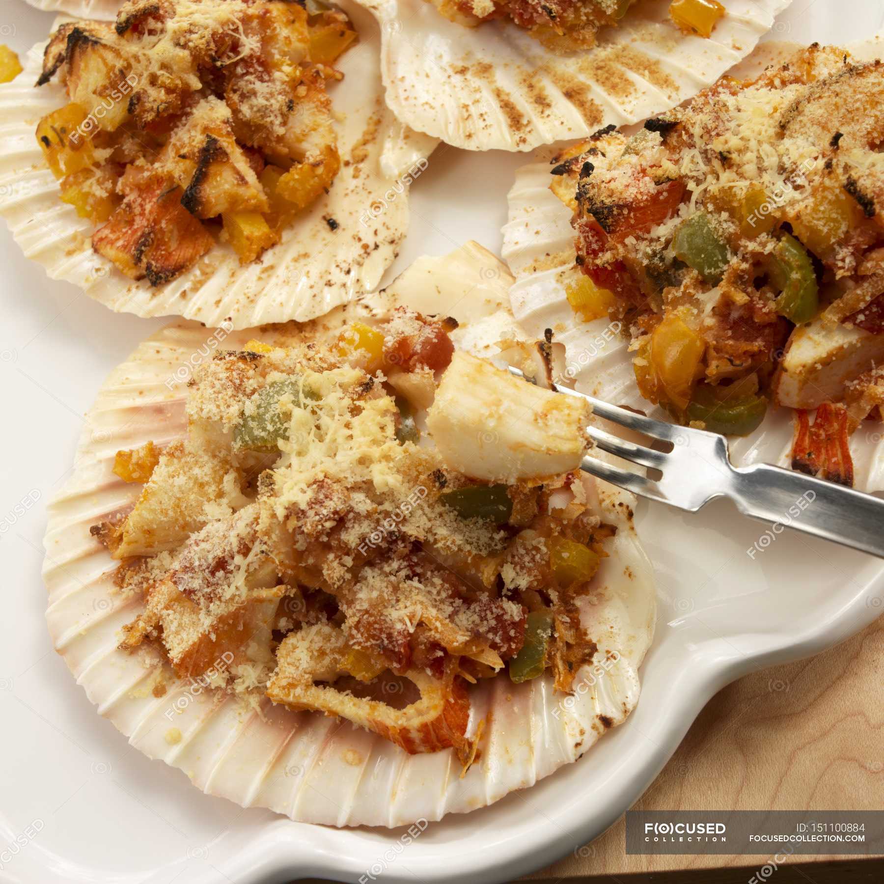 Brazilian Scallop Shells Stuffed with Crab and Coconut on white plate