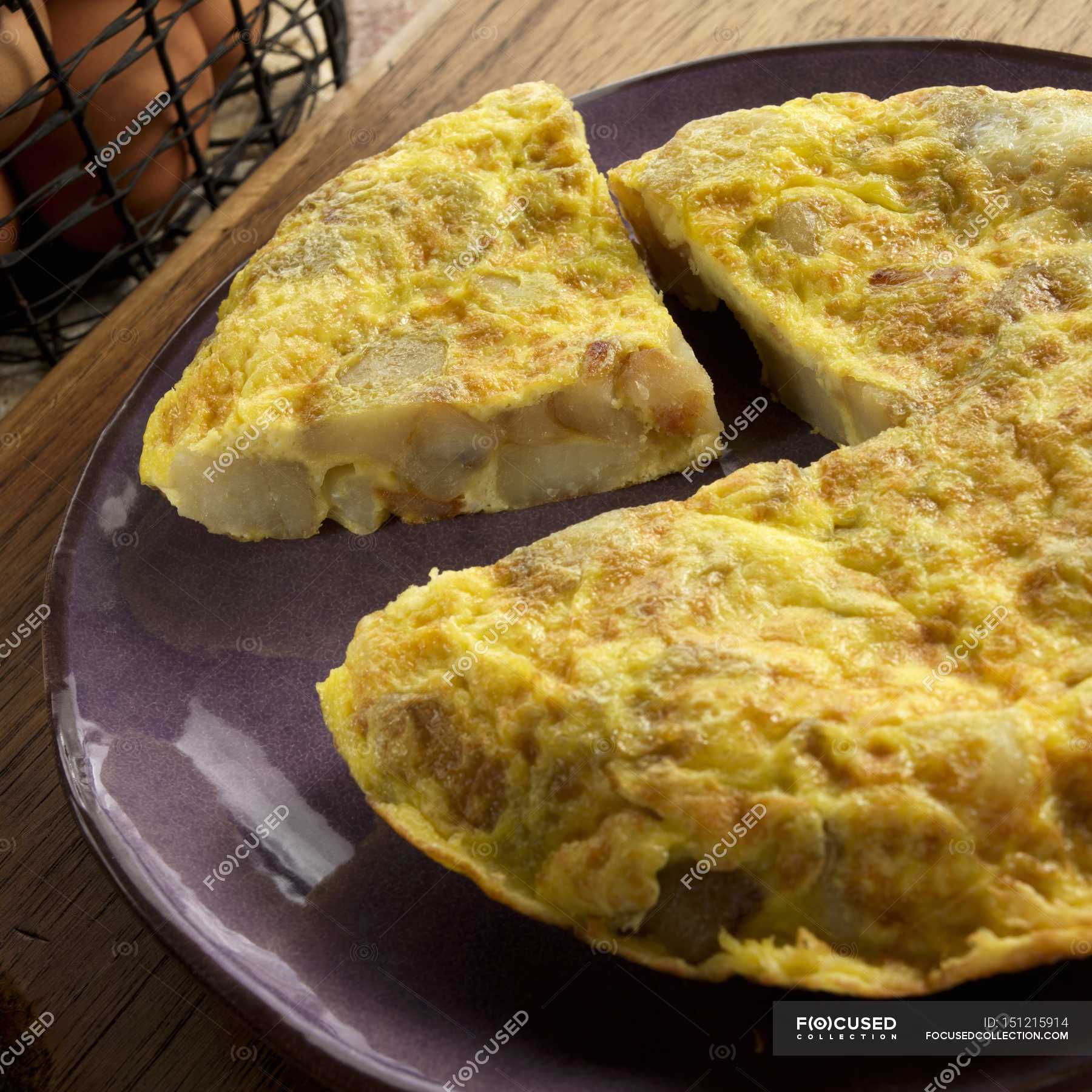 Tortilla Espanola- Spanish Omelet with Potatoes and Onions on plate ...