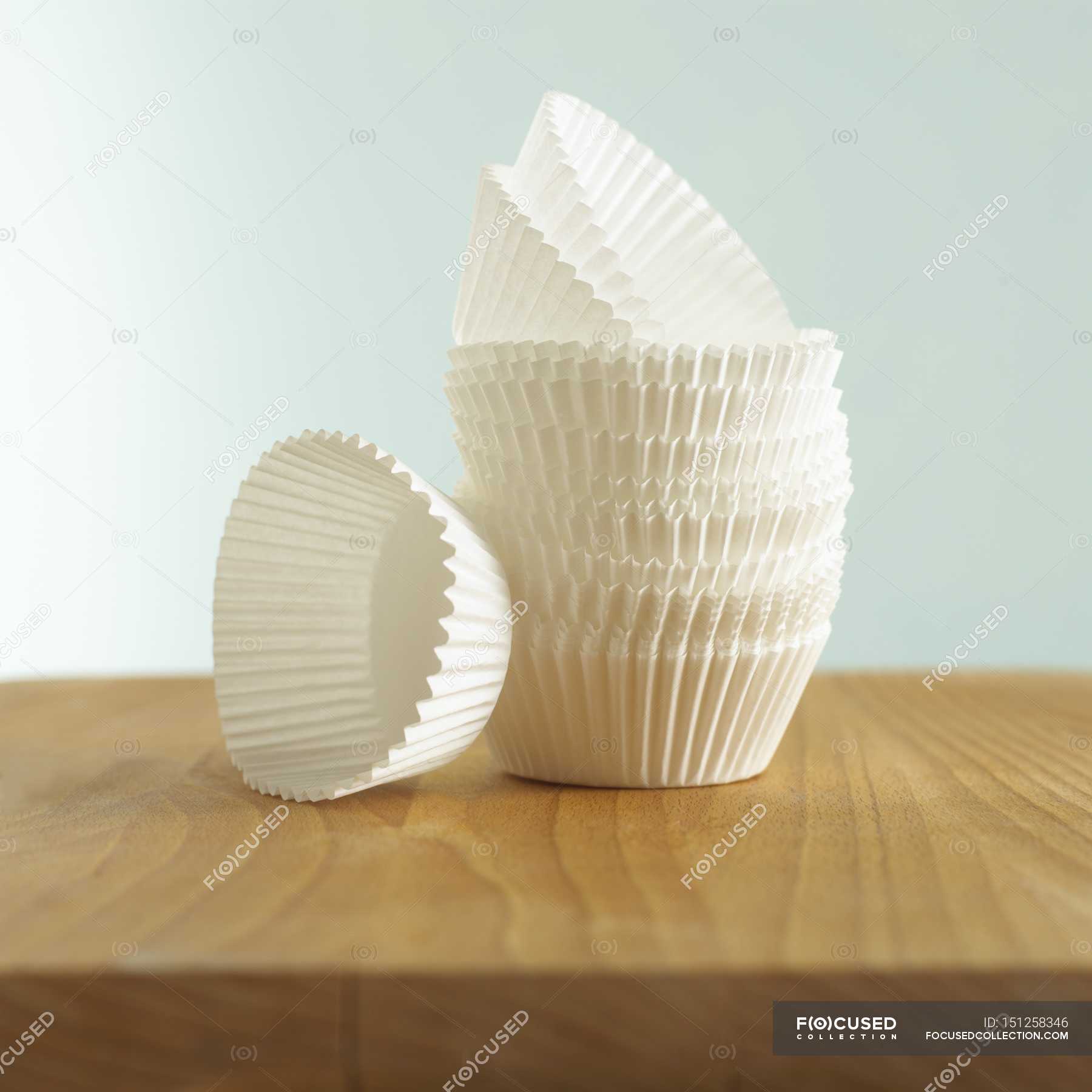 Closeup view of a stacked paper cases on wooden surface — close up, colors Stock Photo