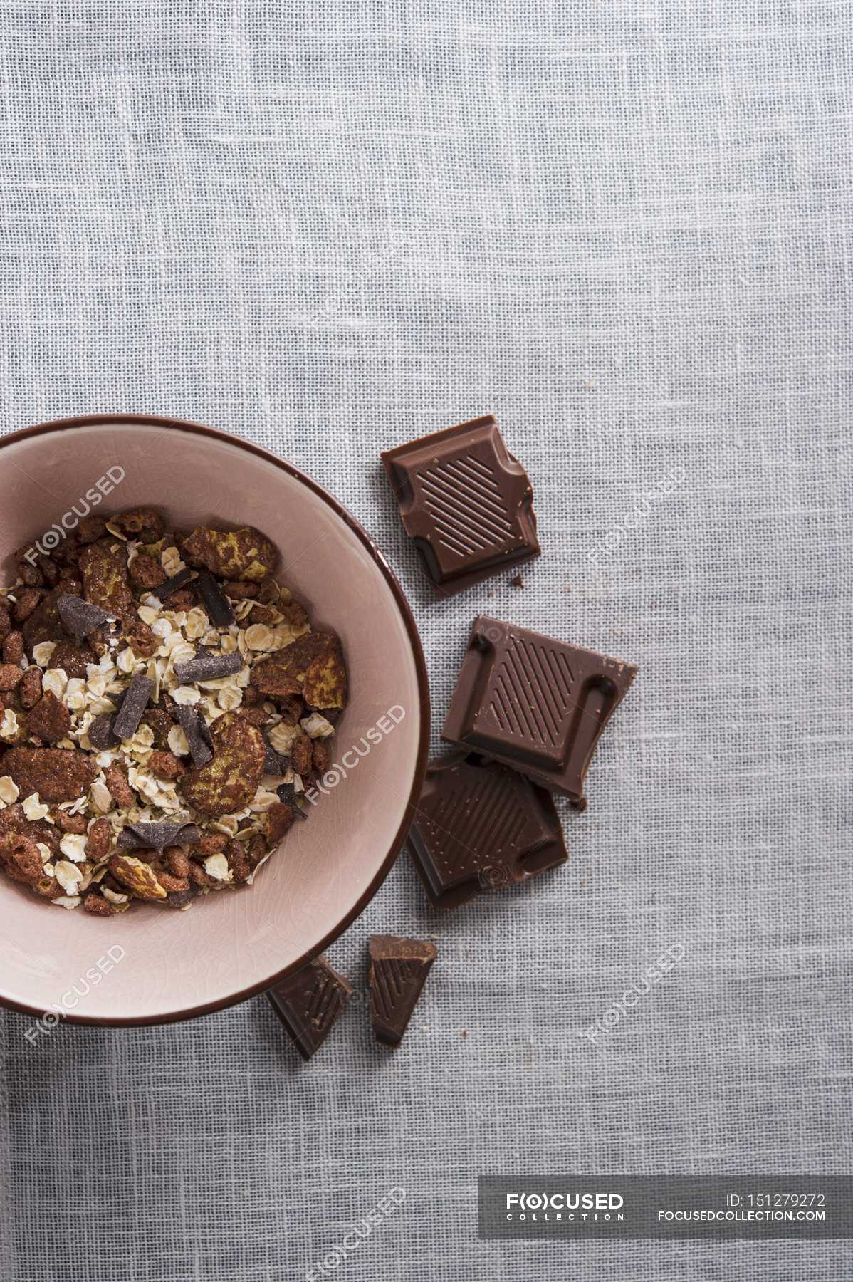 Bowl of chocolate muesli — cereal, flakes Stock Photo 151279272