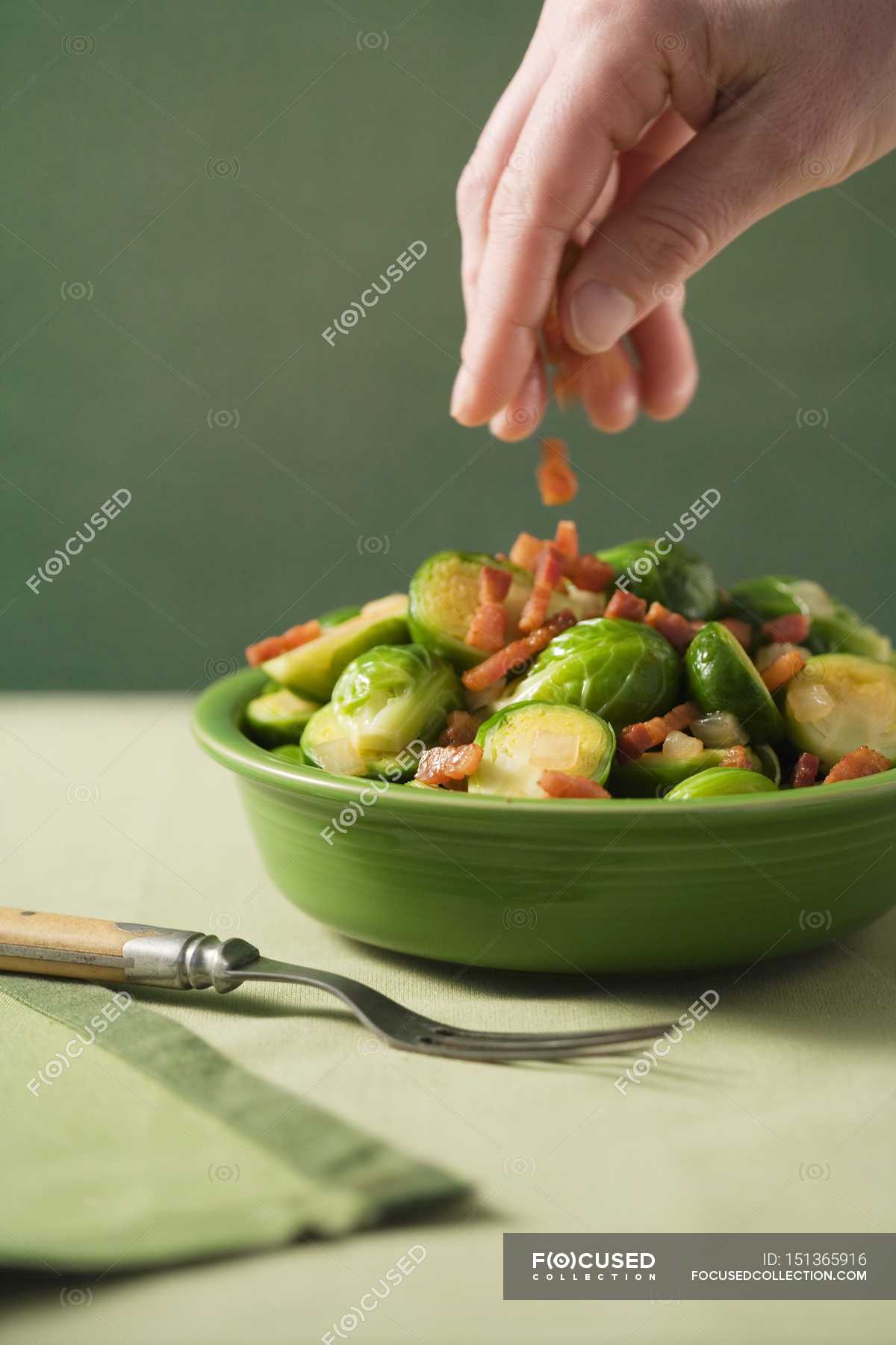 Hand Sprinkling Pancetta — calories, ration Stock Photo 151365916