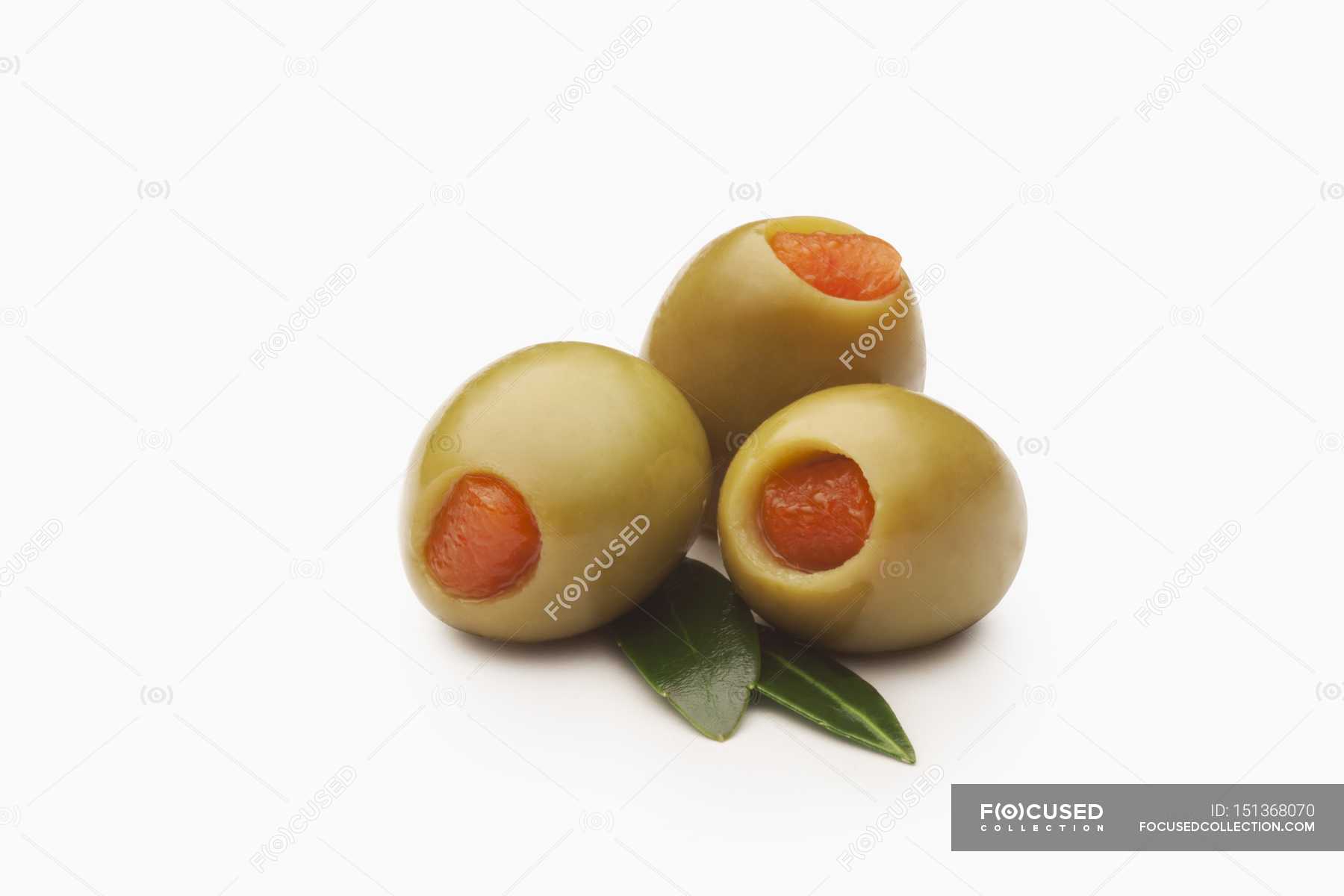 Green Olives Stuffed with Pimentos — three, white Stock Photo