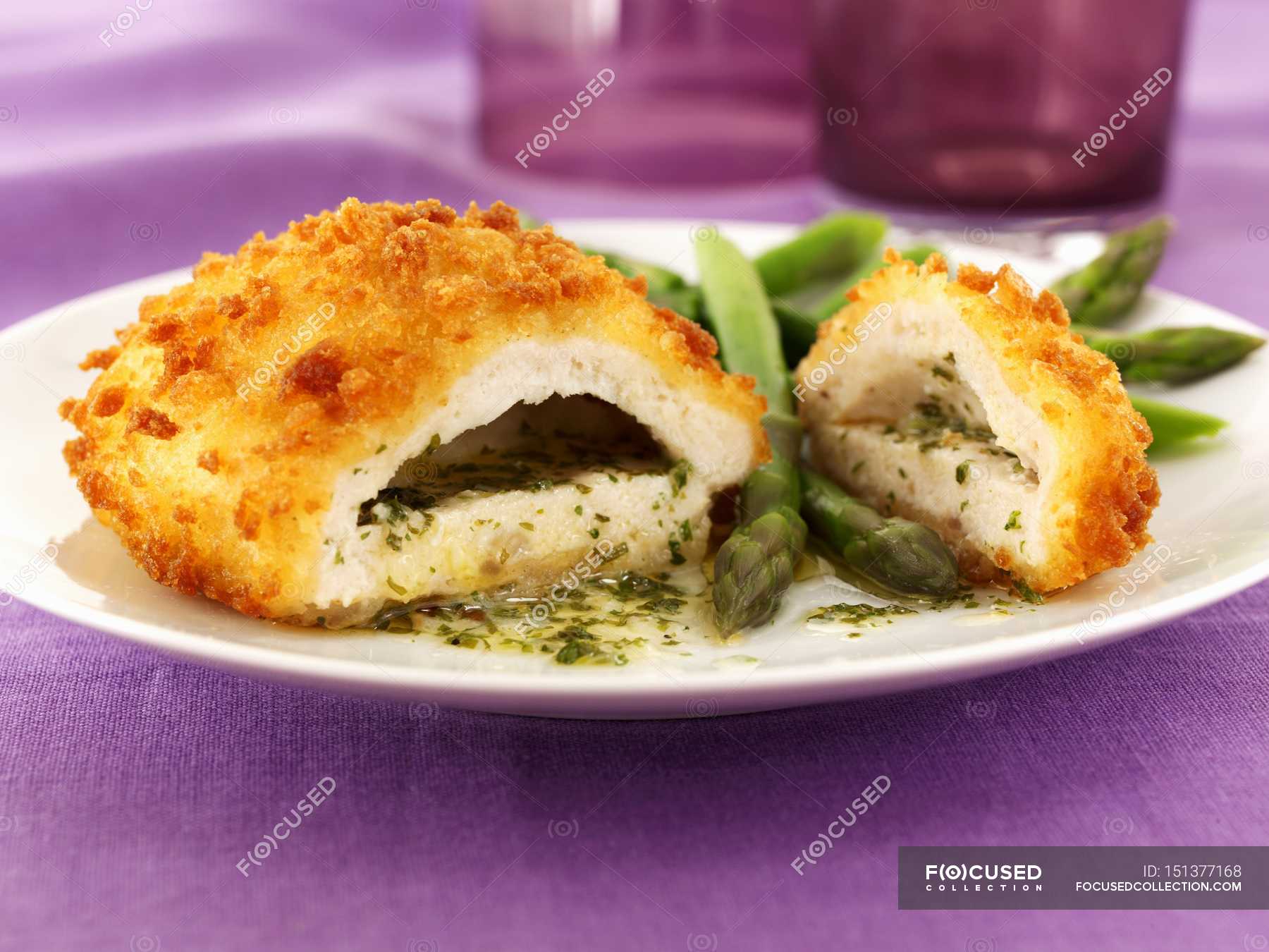 Chicken Kiev With Garlic Butter, Herbs And Asparagus On White Plate ...