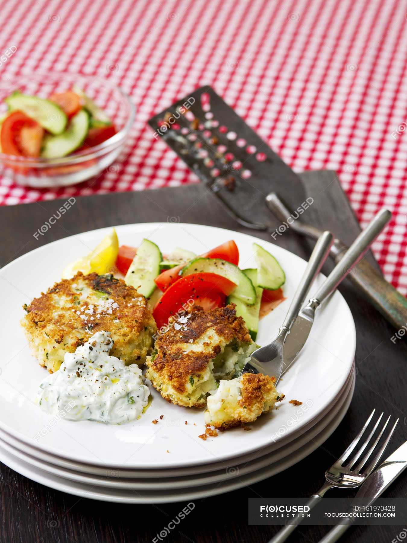 Smoked haddock fish cakes — table setting, salad Stock Photo 151970428