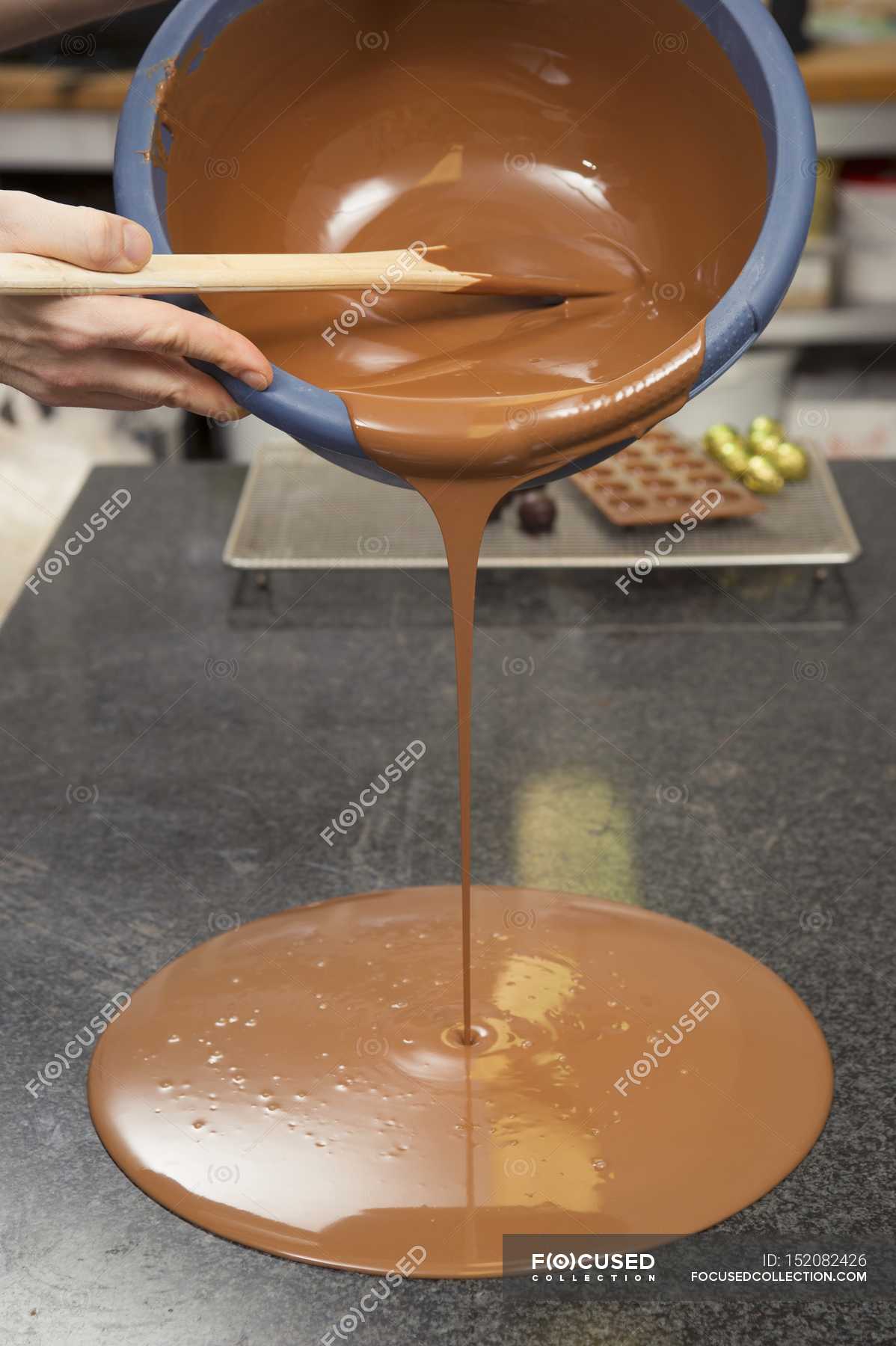 Hand Pouring Melted Chocolate — Gourmet Surface Stock Photo 152082426