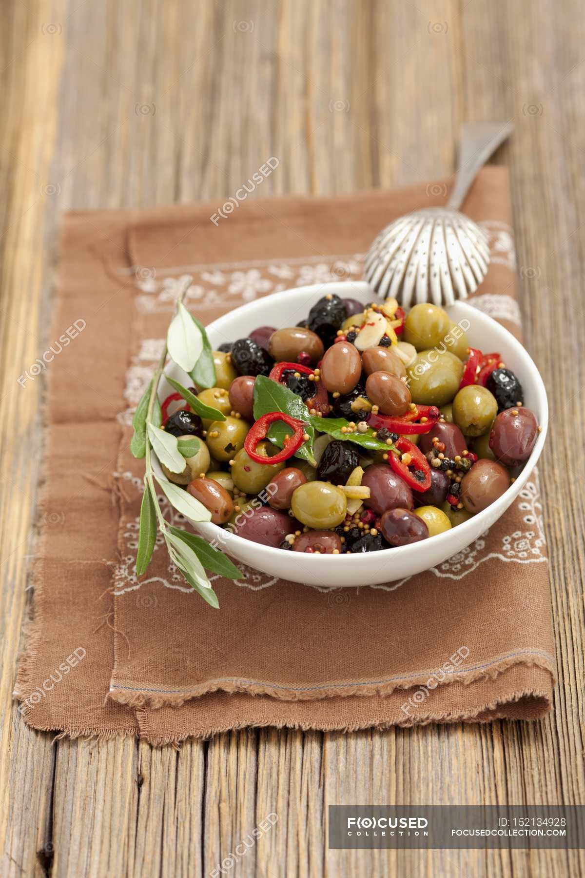 Mixed Marinated Olives With Garlic Mustard And Chilli On White Plate