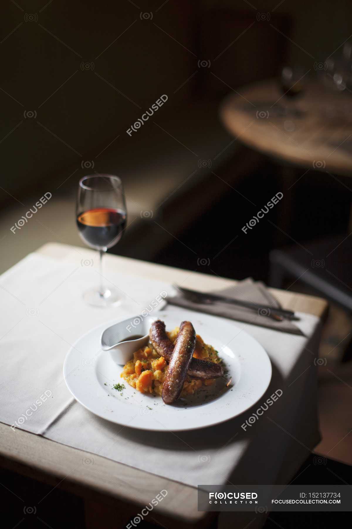 Belgian Sausages With Vegetable Pure On White Plate Over Table With