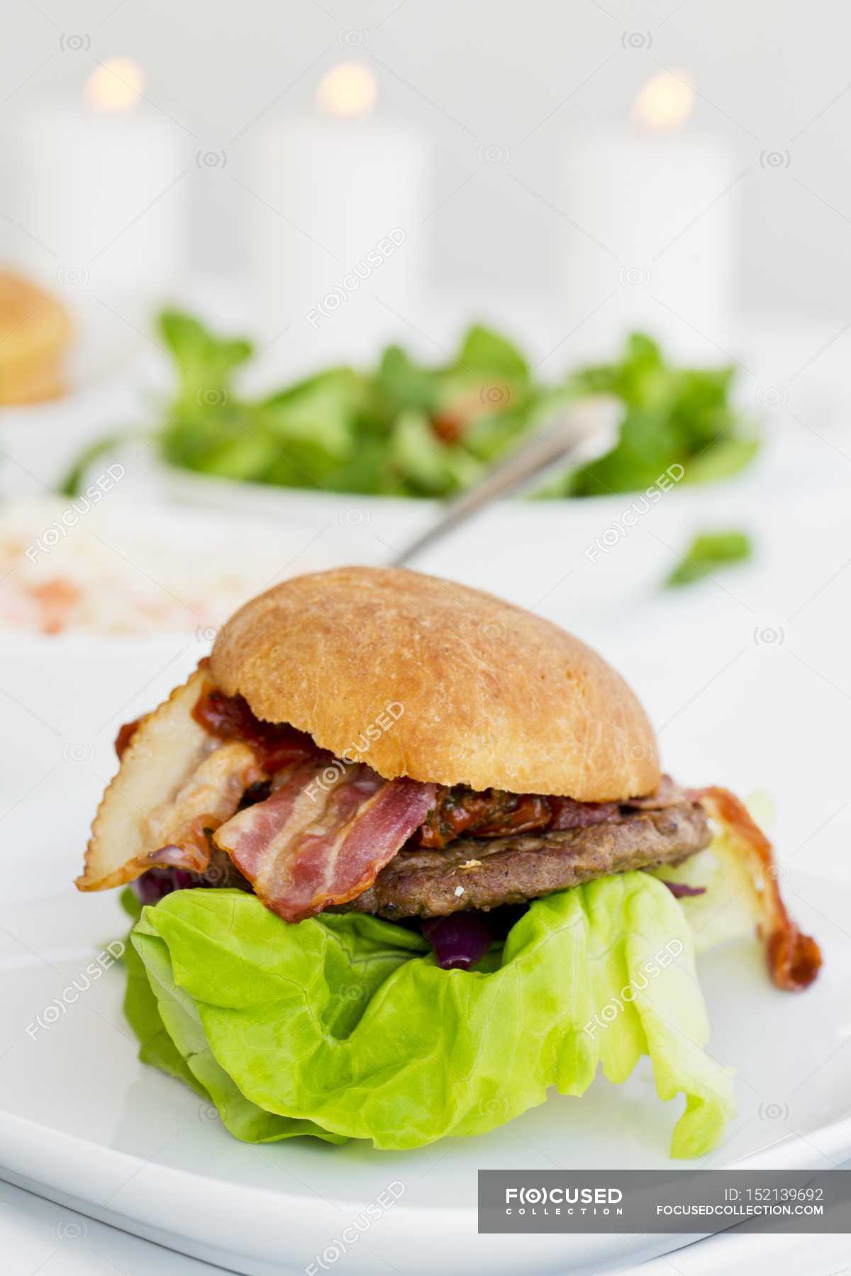 Hamburger with bacon and lettuce — snack, calories Stock Photo