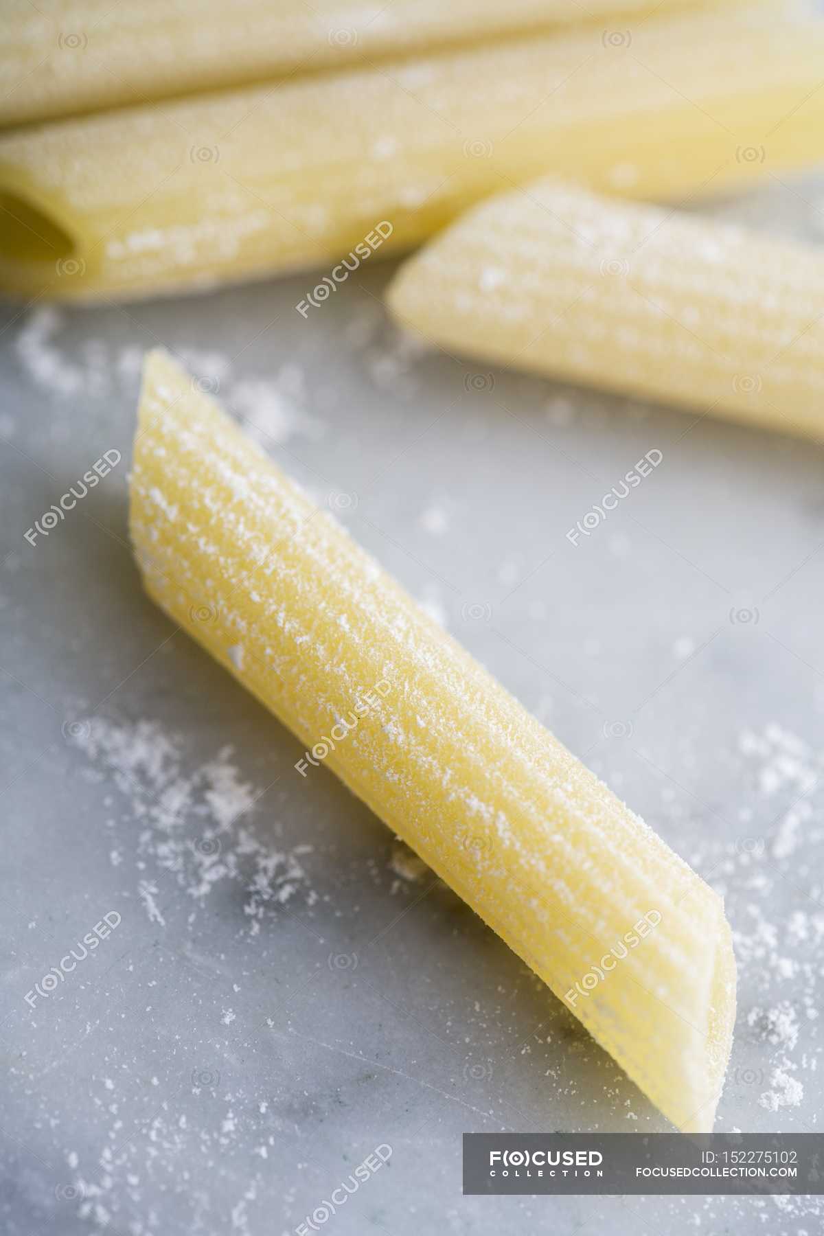 Fresh Penne Rigate pasta — indoors, appetizing - Stock Photo | #152275102