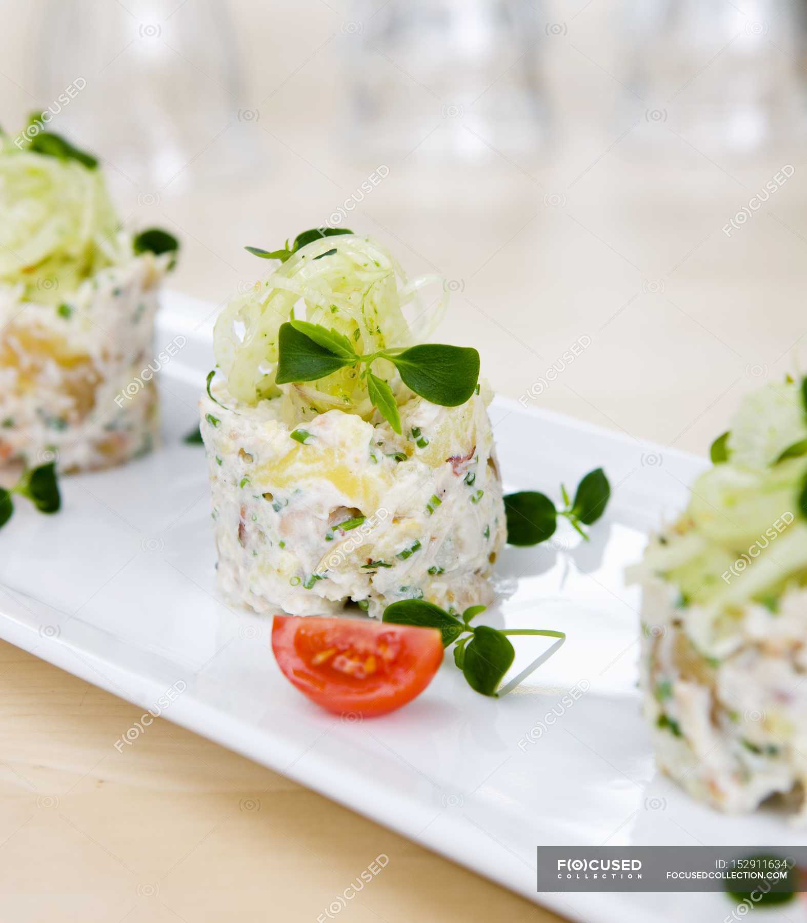 Mashed potatoes with a crab and fennel salad on white plate