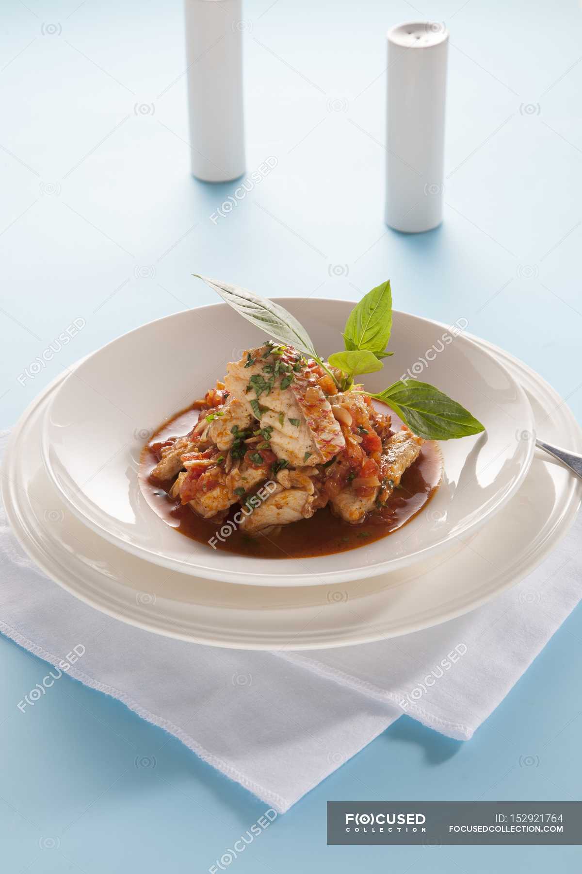 Baked red snapper in tomato sauce on white plate — elements, tasty ...