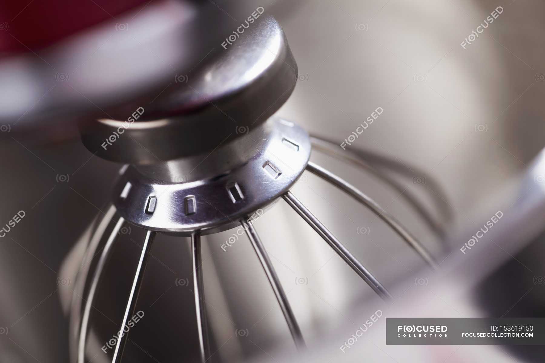 Closeup view of a food processor fitted with egg whisk attachment
