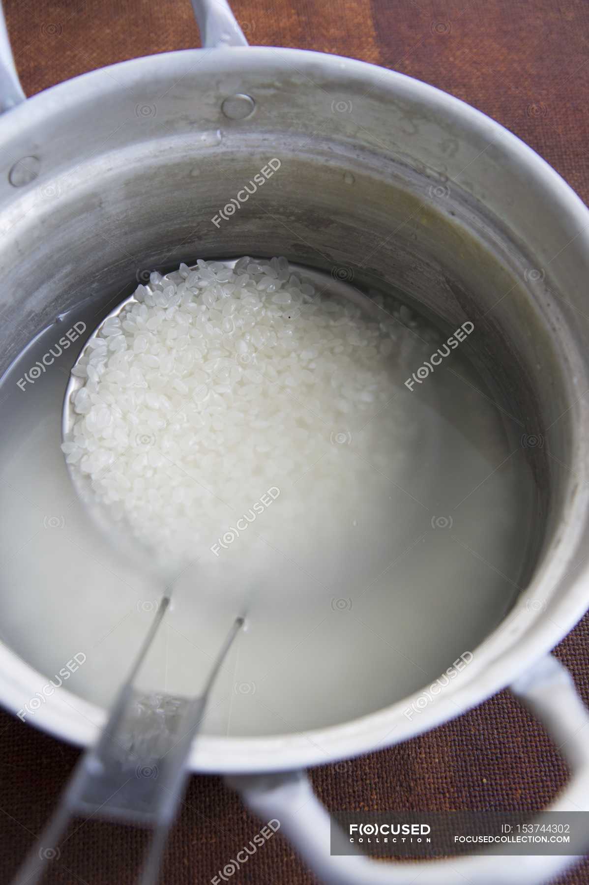 Rice being cooked in pot — ingredients, tasty Stock Photo 153744302