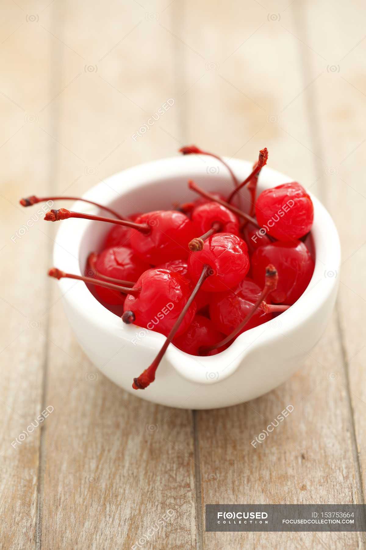 Cherries preserved in syrup — color, bowl Stock Photo 153753664