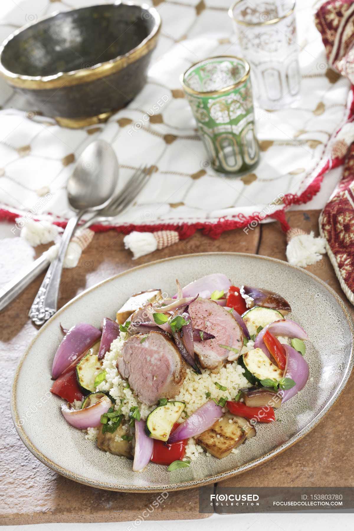 Couscous with vegetables and pork tenderloin — dish, calories Stock