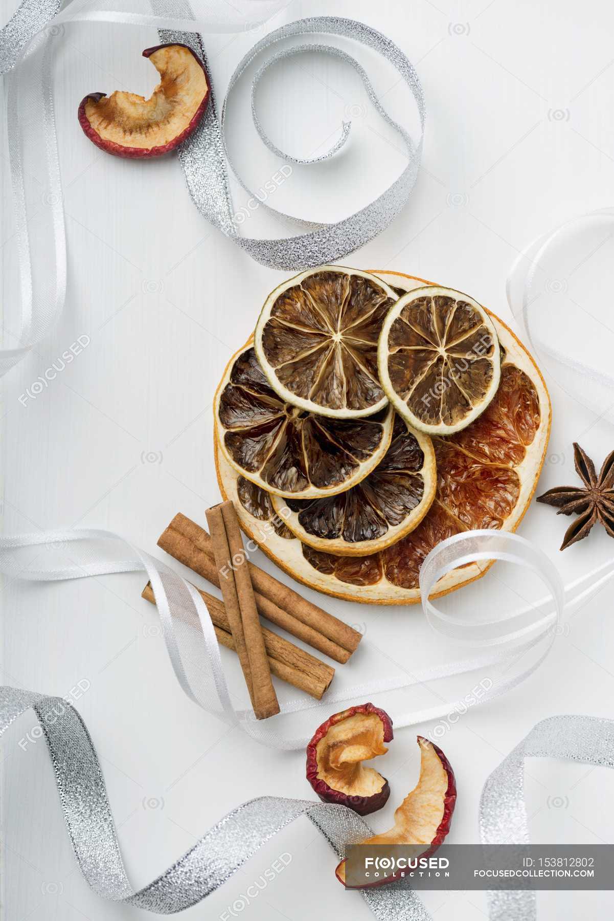 Top View Of Dried Fruit With Cinnamon Sticks And Ribbons — Meal Colors