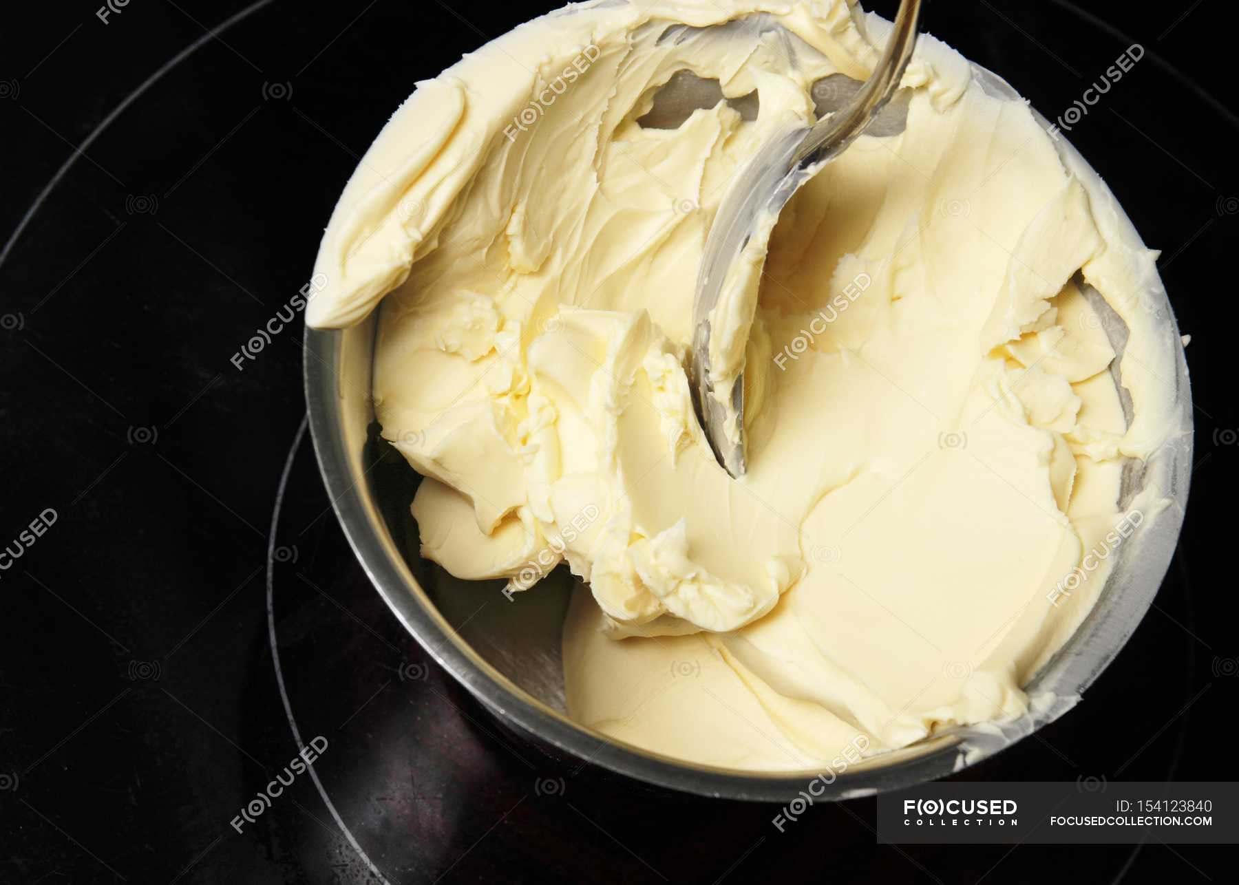 Closeup view of melting butter with spoon in bowl — colors, Color Image