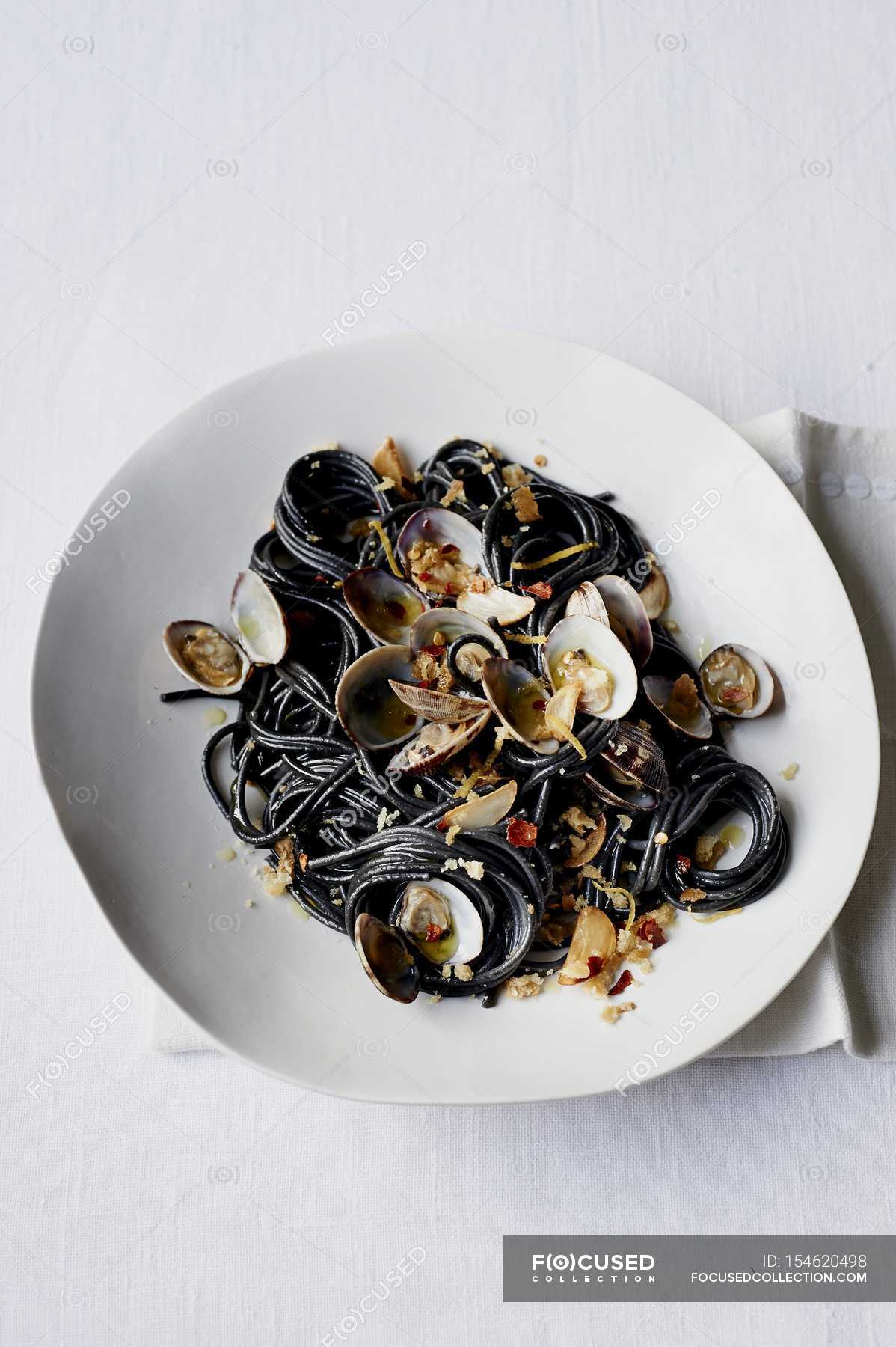 Black squid ink spaghetti — edible, ingredients Stock Photo 154620498