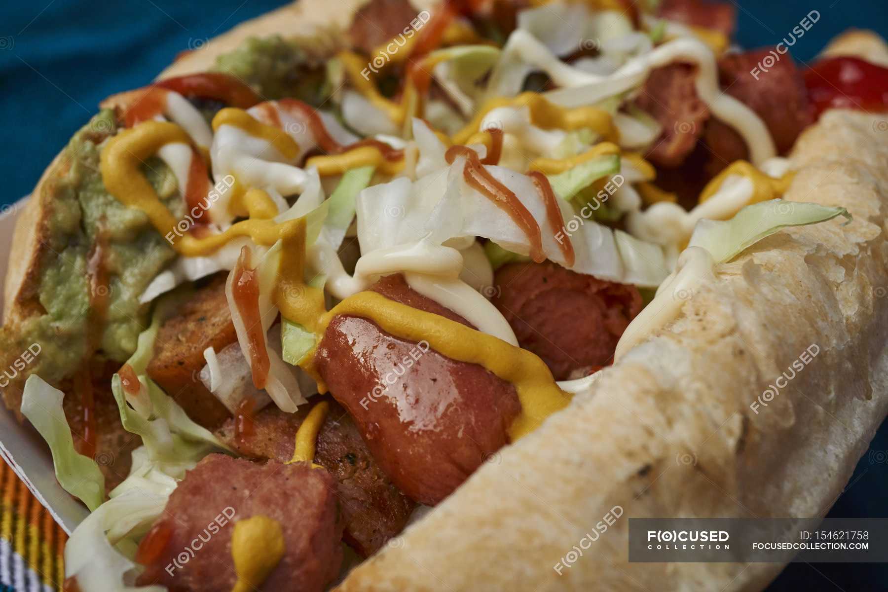 Hot dog with cabbage and guacamole — yummy, unhealthful Stock Photo