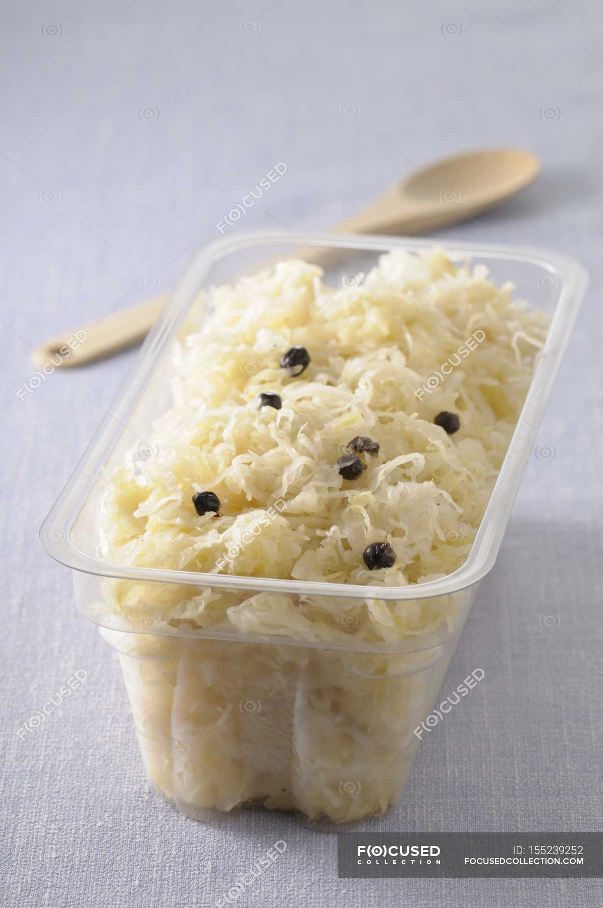 Closeup view of Sauerkraut in plastic container — appetizing, nutrition