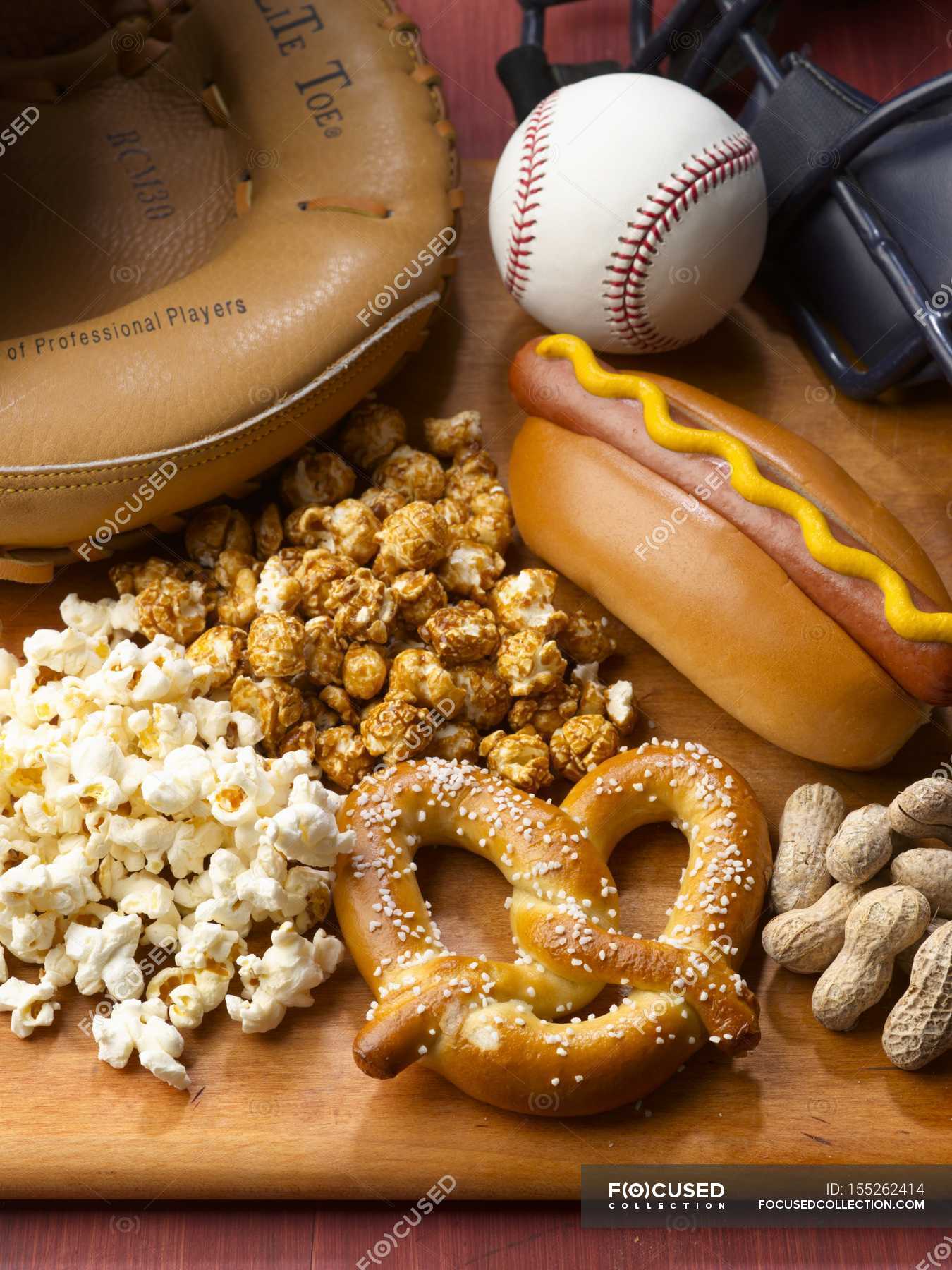 Closeup view of baseball game food — glove, nuts Stock Photo 155262414