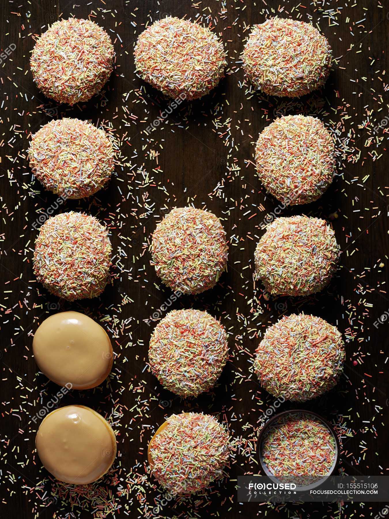 Caramel doughnuts with sugar icing and sprinkles — view, cuisine