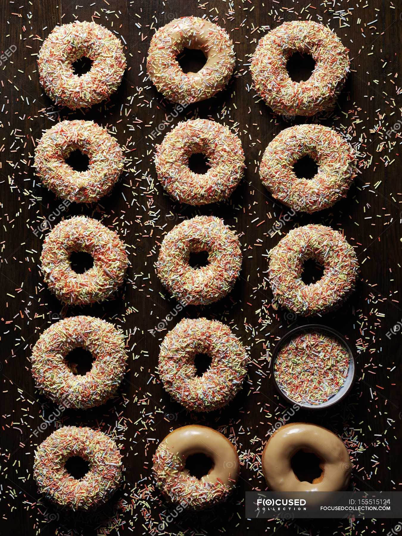 Caramel doughnuts with sugar icing and sprinkles — unhealthy, color