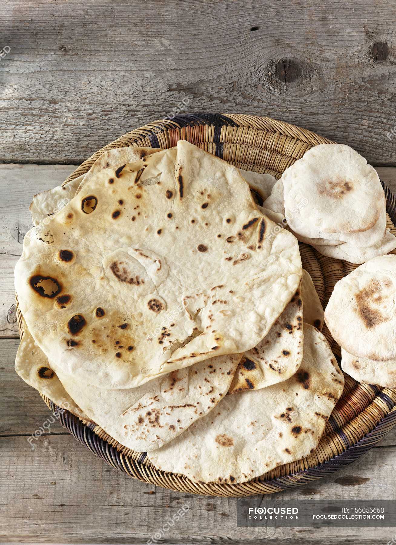 Unleavened bread and pita — loaf, basket Stock Photo 156056660