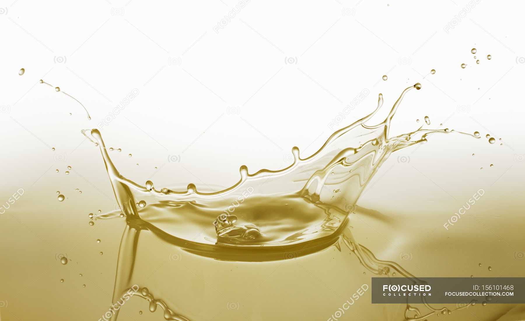 Download Closeup View Of A Splash Of Yellow Oil Drinkable Calories Stock Photo 156101468 PSD Mockup Templates