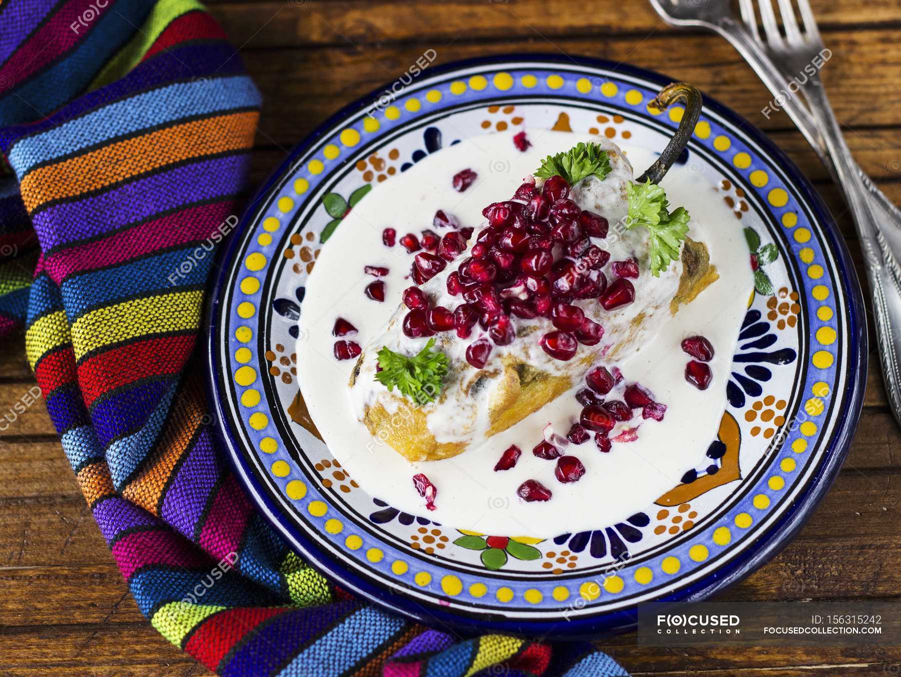 Chiles en Nogada Chile Poblano relleno con salsa de nuez y semillas de