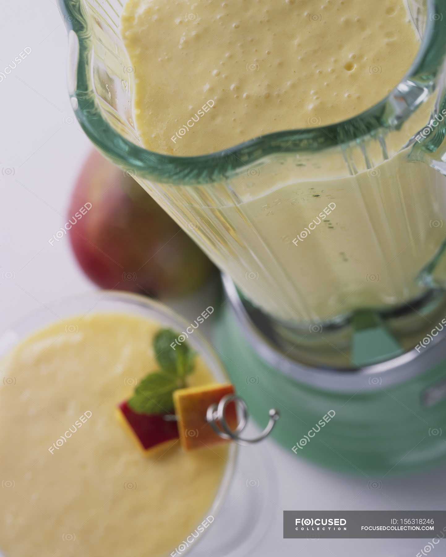 Mango smoothie in blender — ingredients, fruit Stock Photo 156318246