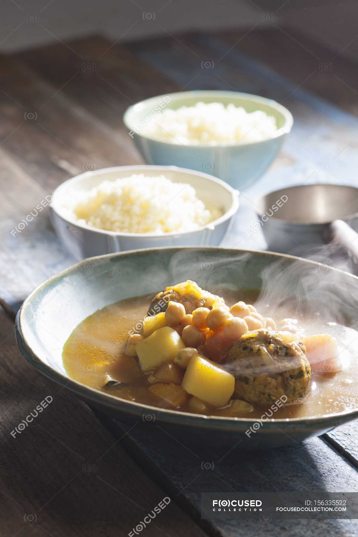 Steaming Soup With Couscous Chickpeas And Turkey Meatballs Over Wooden Surface Fresh Vegetables Stock Photo 156335522