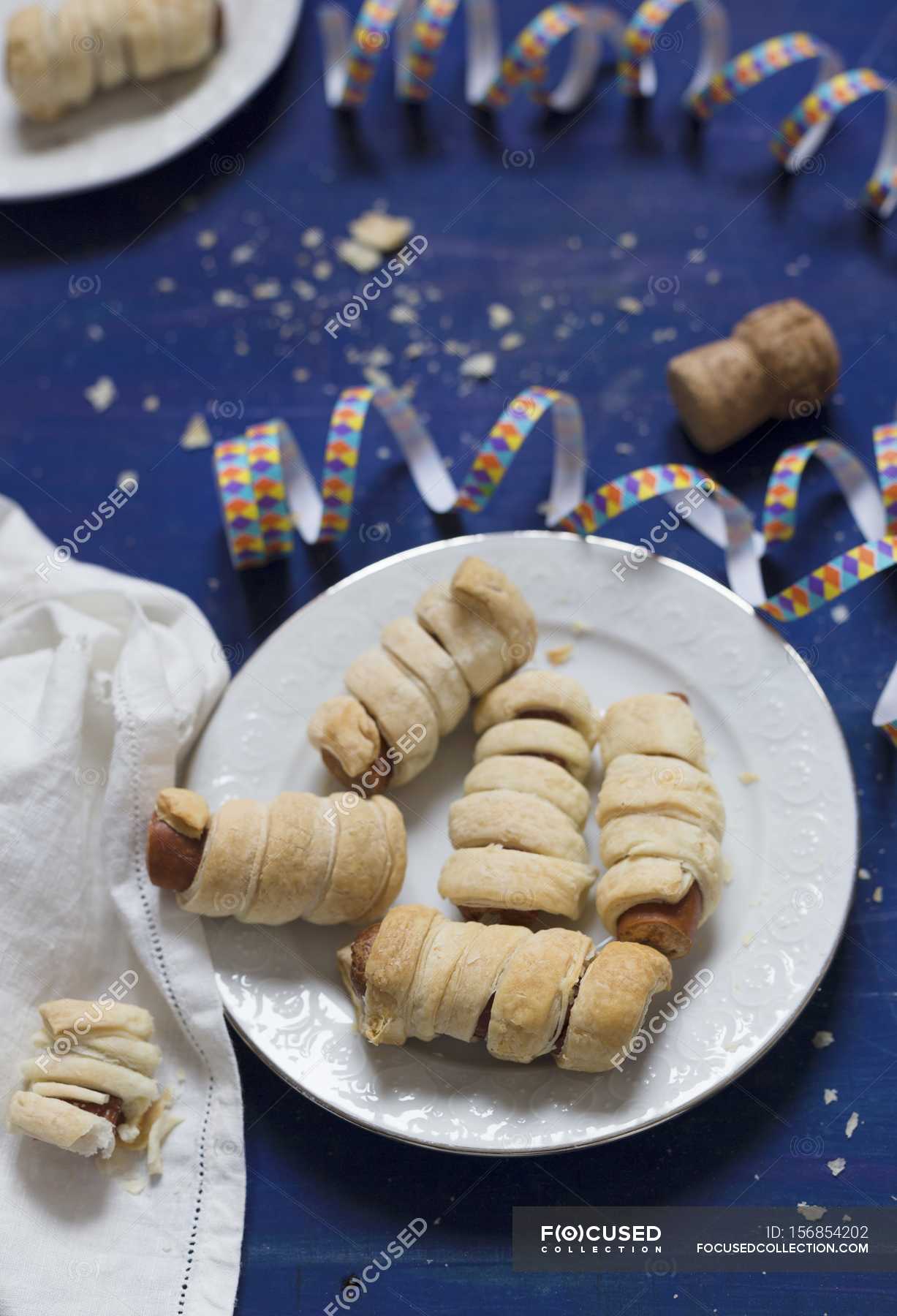 Elevated View Of Sausages Wrapped In Puff Pastry With Party