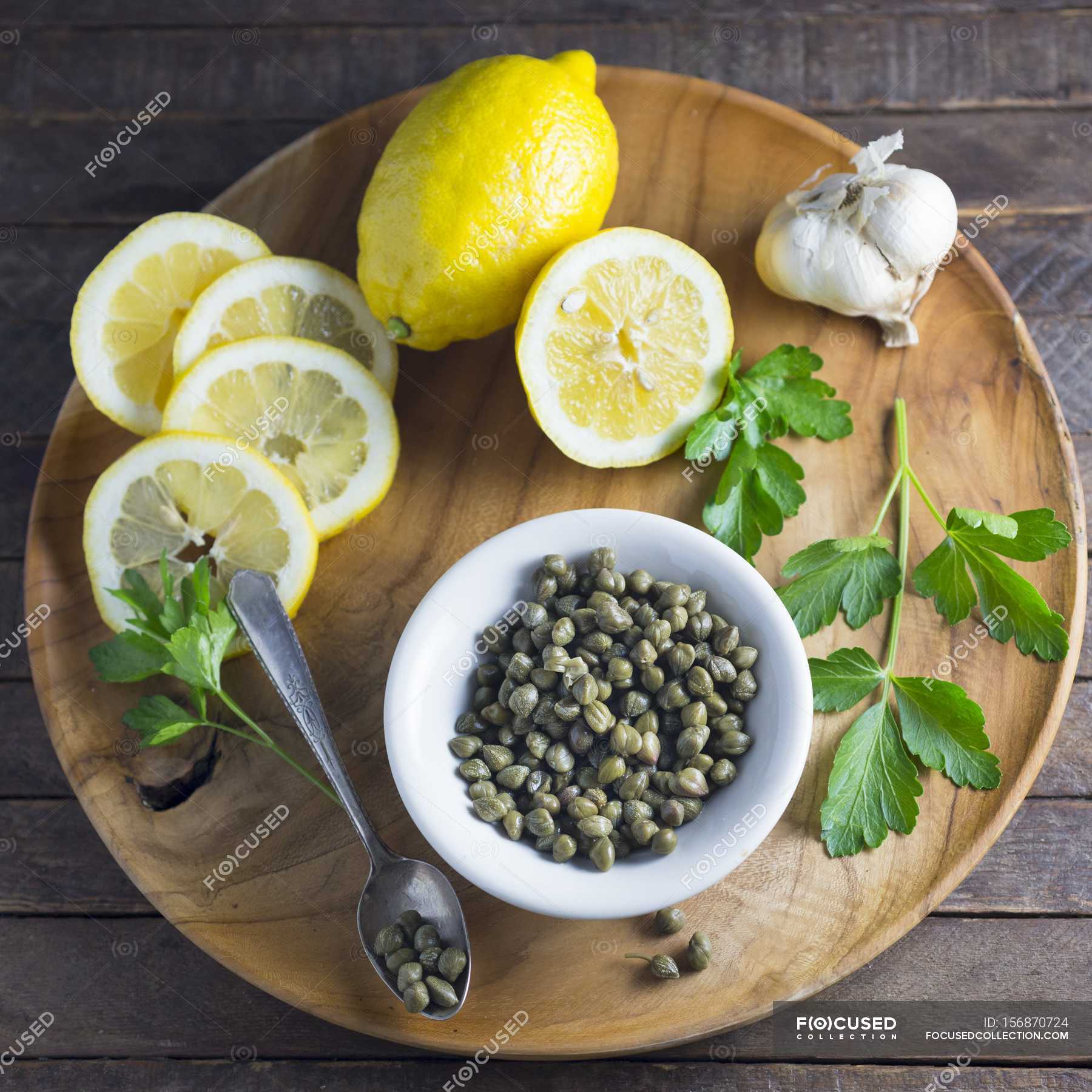 Capers with Lemons and garlic — edible, flavouring Stock Photo