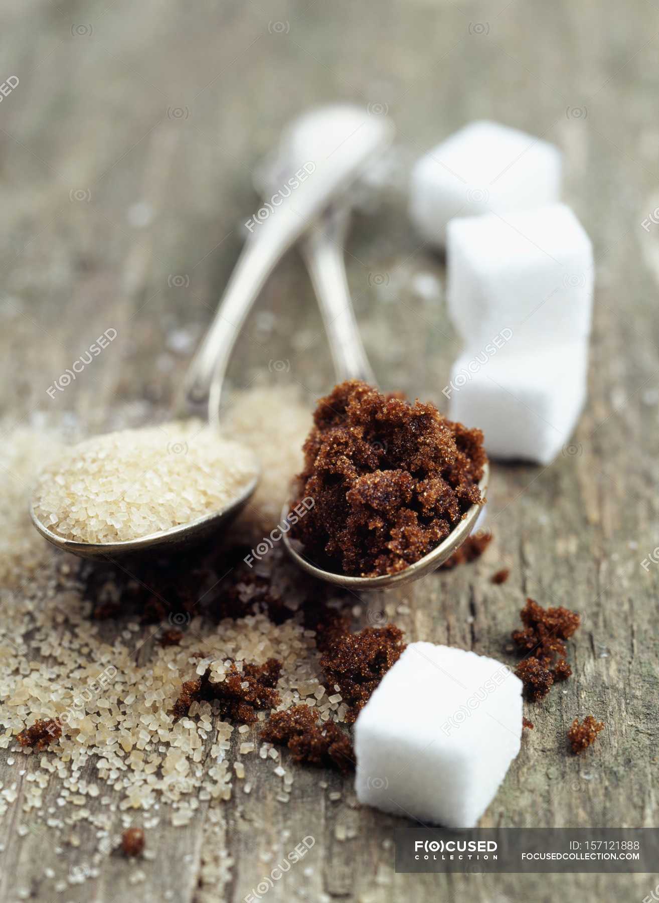 Assorted sugars in spoons — surface, cane sugar Stock Photo 157121888