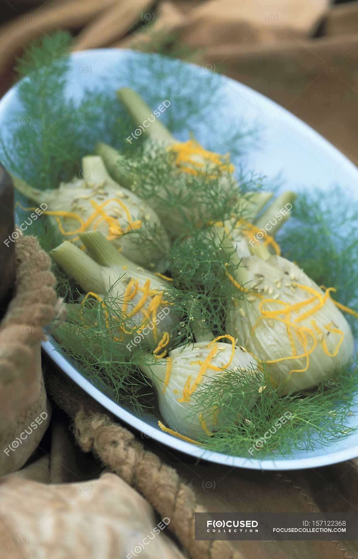 Fennel with orange and anise seeds on blue plate — tasty, healthy
