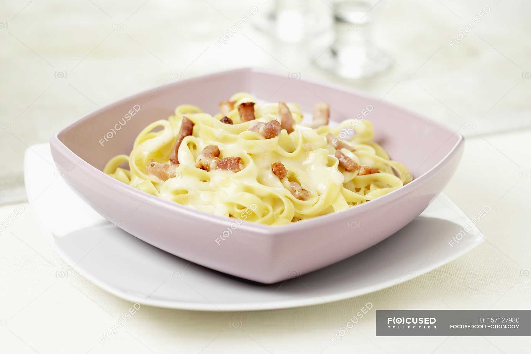 Tagliatelle carbonara pasta with bacon — meal, background Stock Photo 157127980