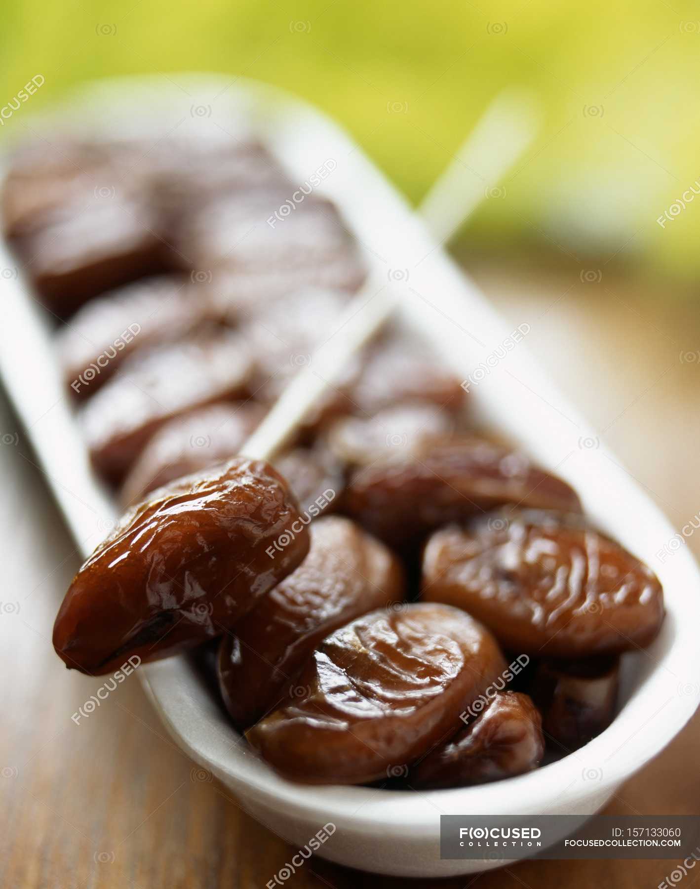 Dish of dried Dates — healthy food, vegetarian Stock Photo 157133060