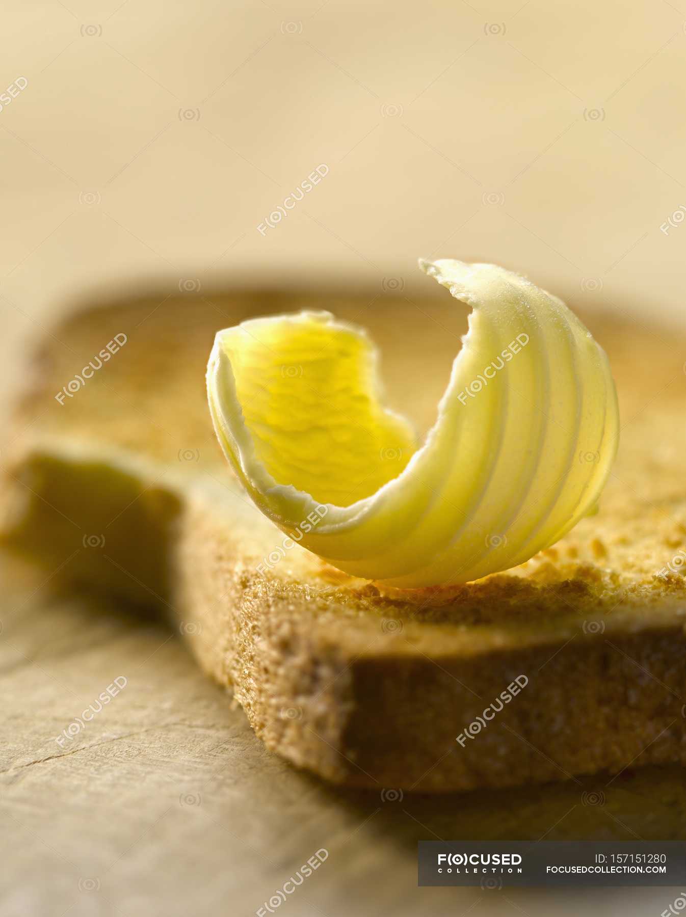 Knob of butter on biscotte — product, eating Stock Photo 157151280