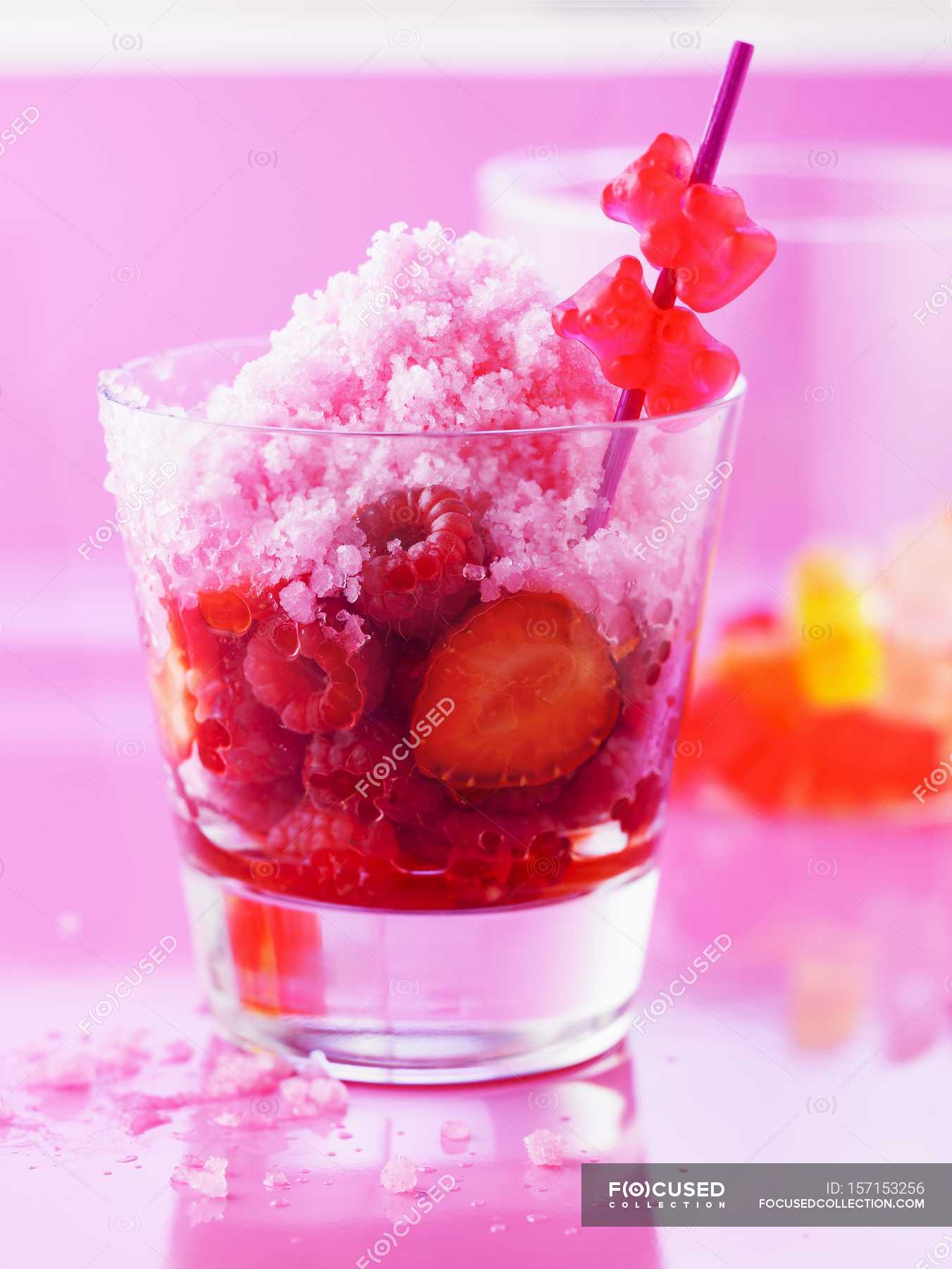 Closeup view of fruit sherbet ice with ginger and jelly bears on stick ...