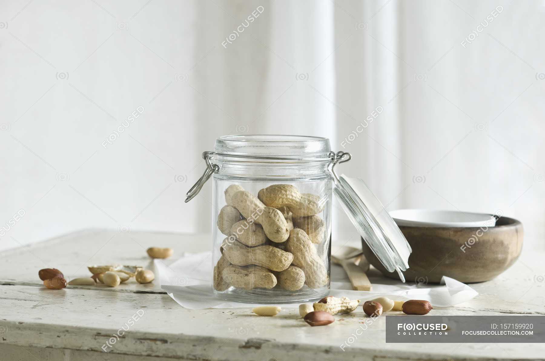 Peanuts In And Next To A Glass Jar On A Rustic Kitchen Table Food Delicious Stock Photo 157159920