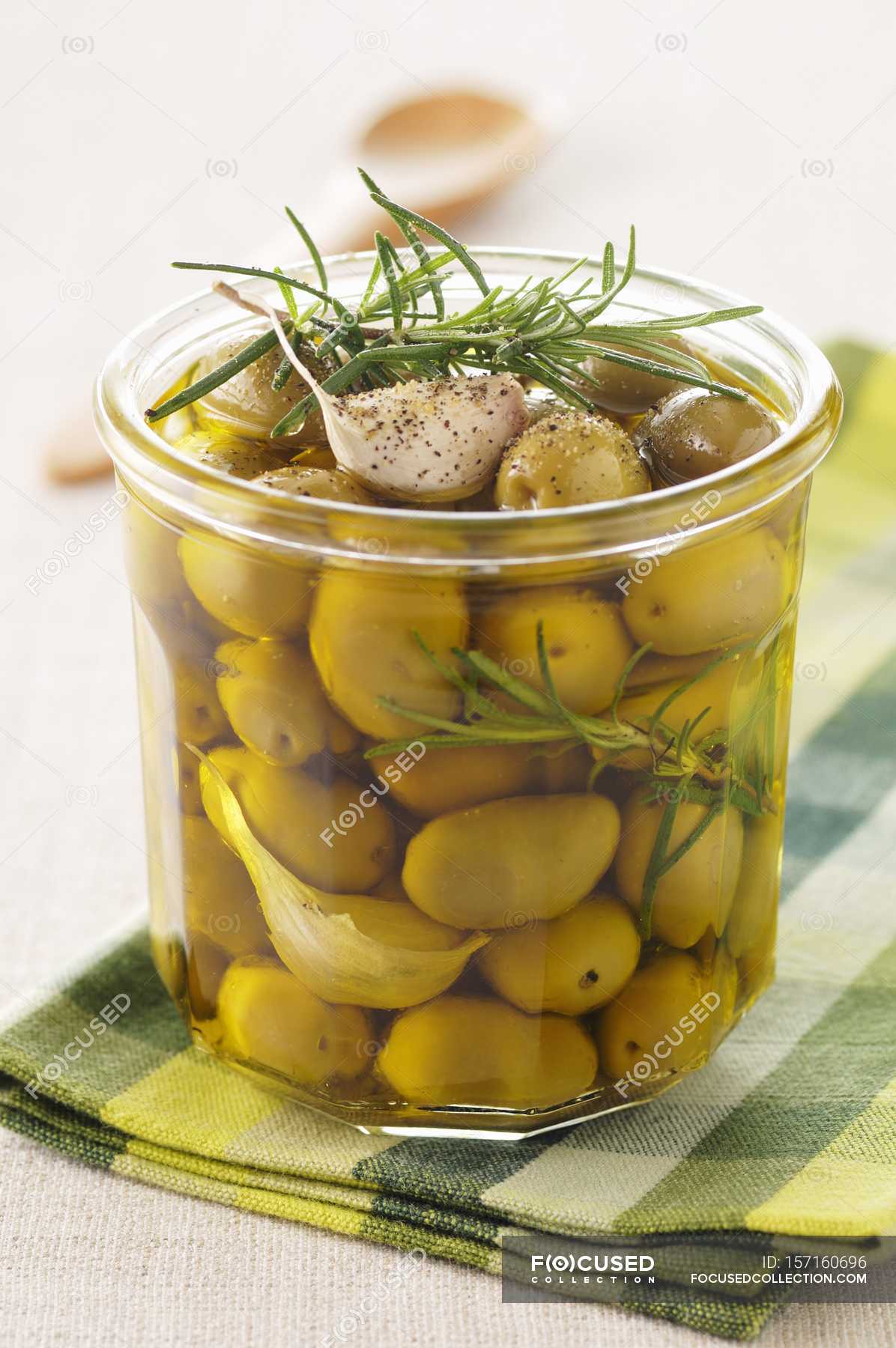 Olives marinated with garlic and rosemary — leaves, gourmet Stock